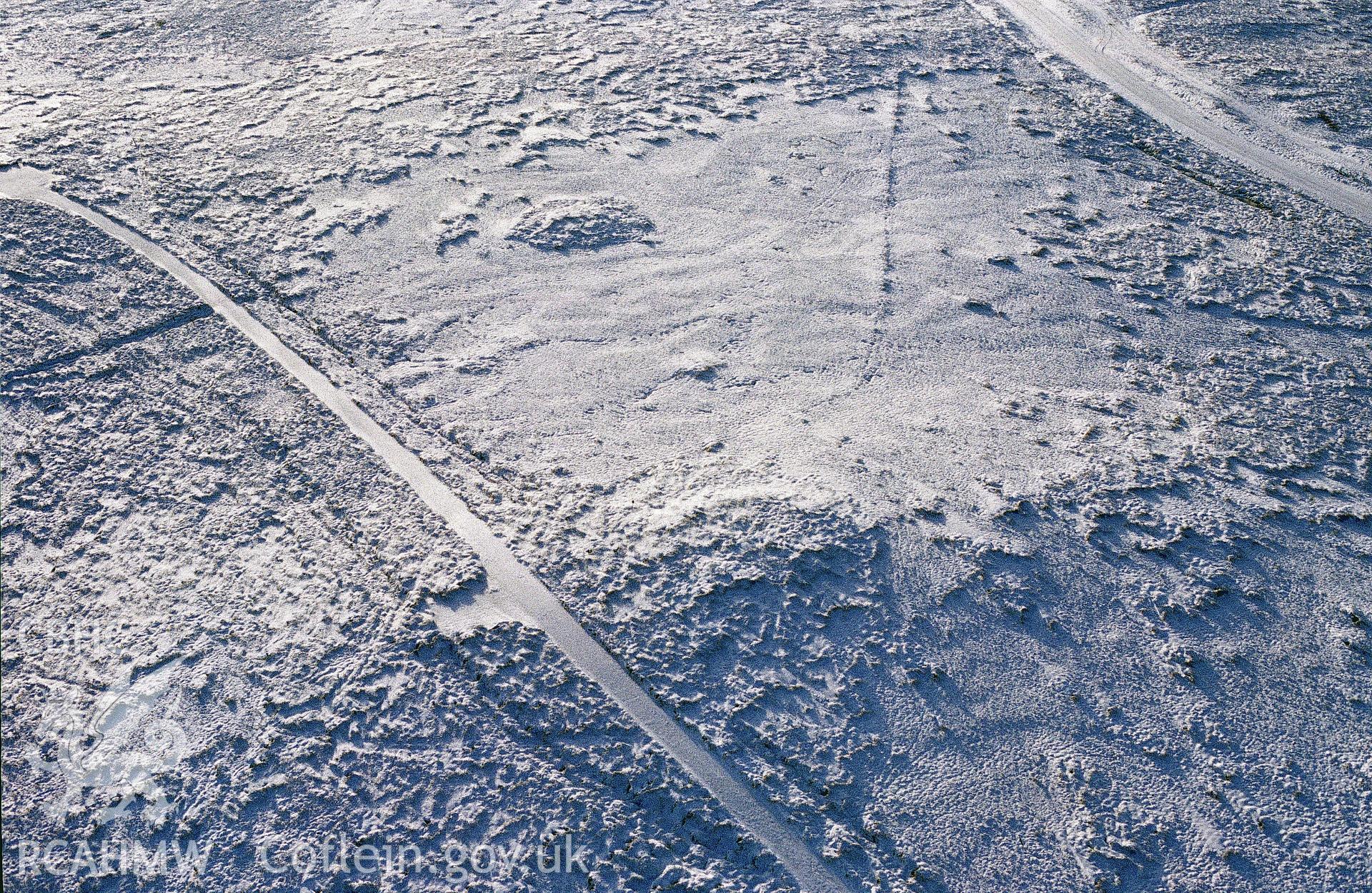 RCAHMW colour slide oblique aerial photograph of Troed-y-rhiw Isaf Cairn I, Llangamarch, taken on 11/01/1992 by CR Musson