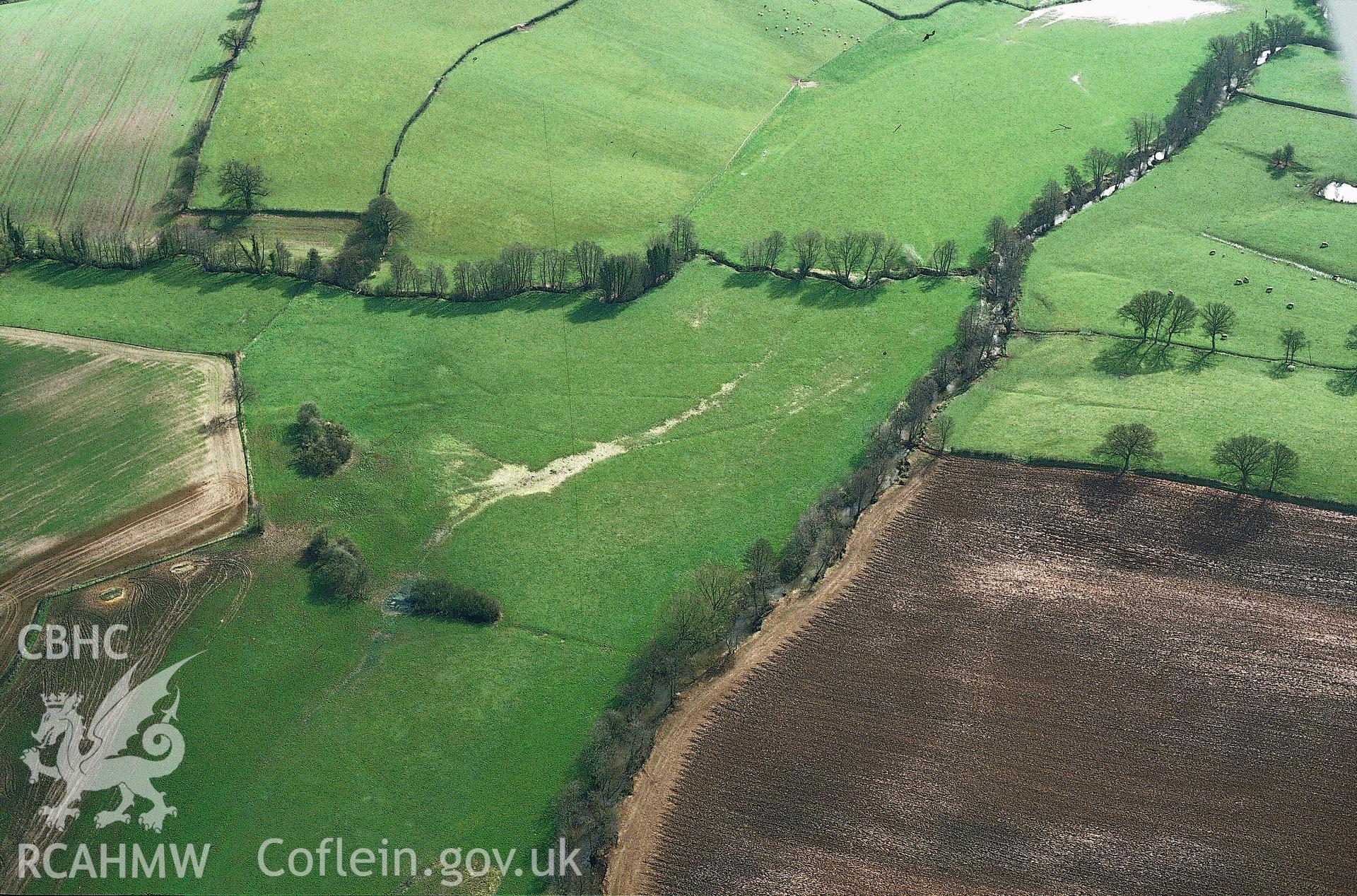 RCAHMW colour slide oblique aerial photograph of Grace Dieu Abbey (Cistercian), Llangattock-vibon-avel, taken by C.R. Musson, 24/03/94