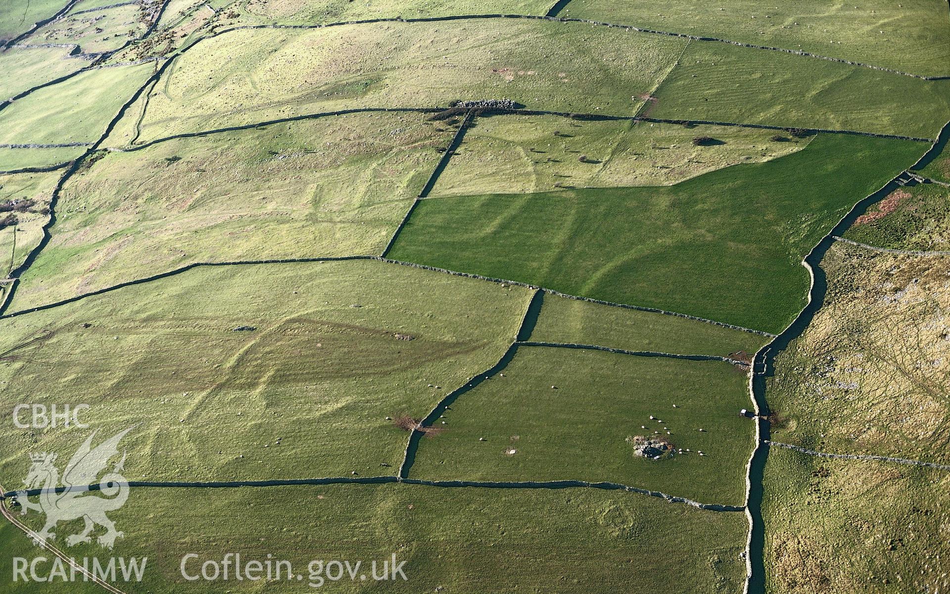 RCAHMW colour slide oblique aerial photograph of Llanbedr Homestead Enclosure, Barmouth, taken on 17/03/1999 by Toby Driver