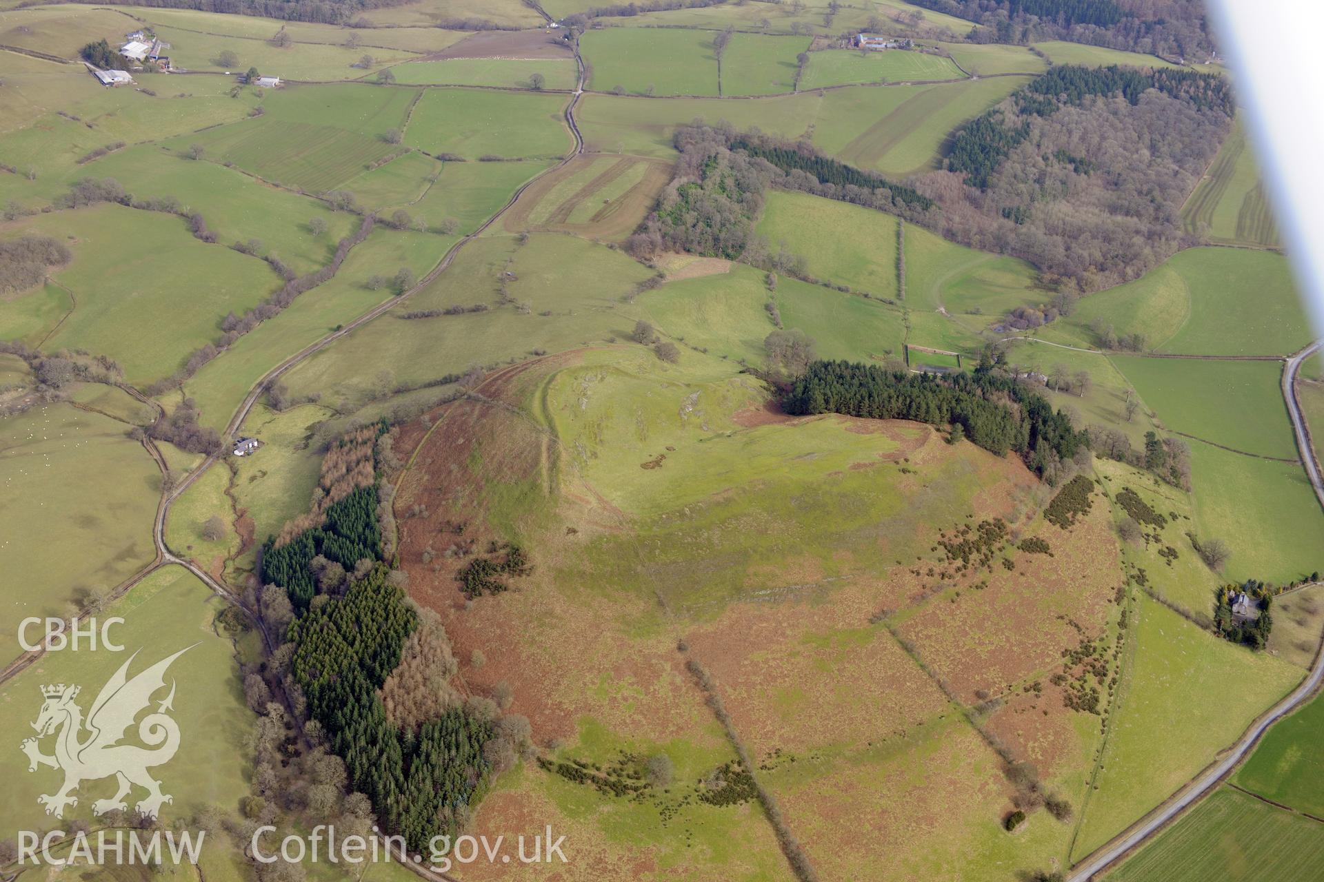 Llwyn Bryn-Dinas hillfort, Llangedwyn, north east of Llanfyllin. Oblique aerial photograph taken during the Royal Commission?s programme of archaeological aerial reconnaissance by Toby Driver on 28th February 2013.