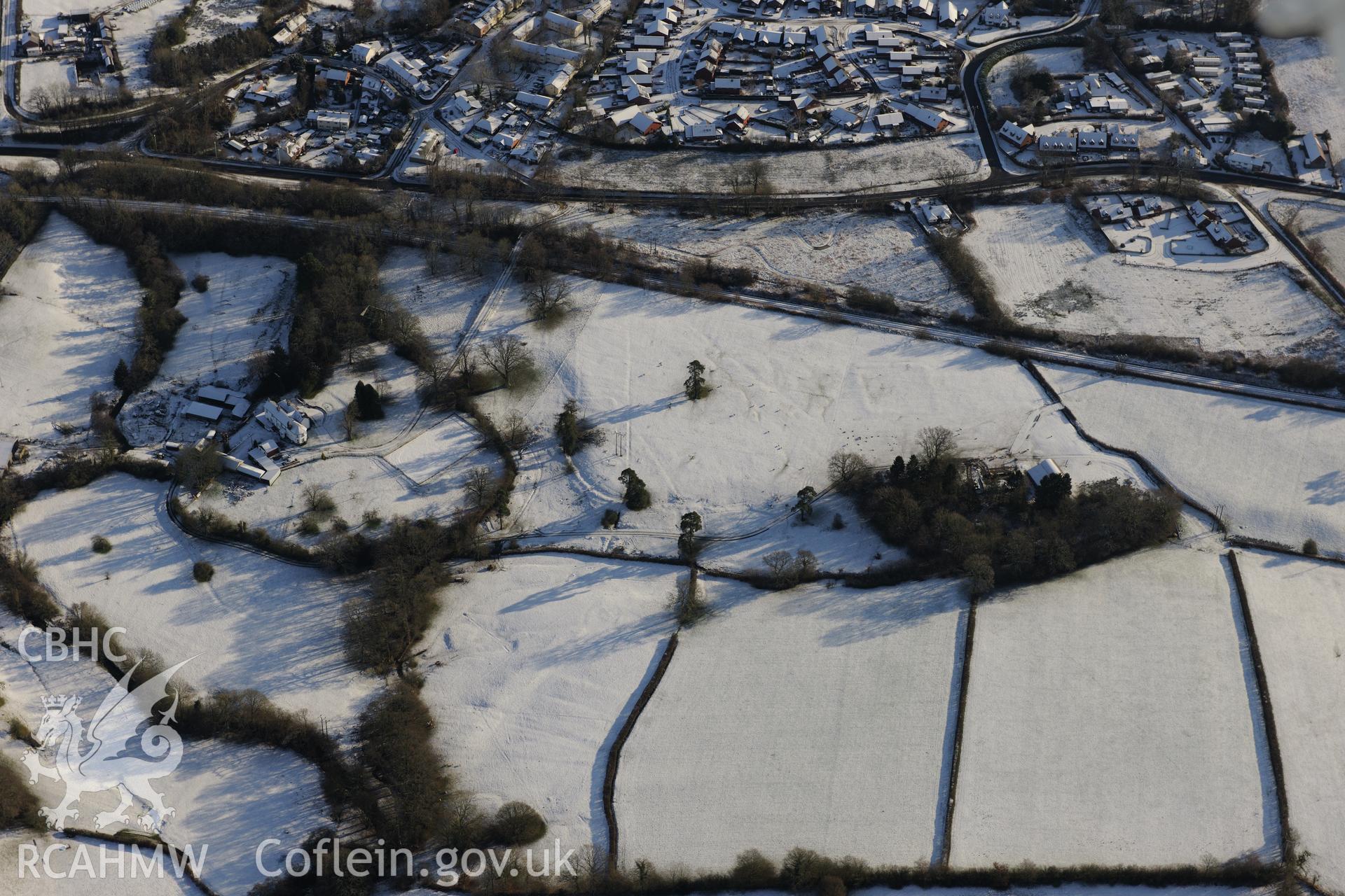 Howey Hall, the enclosure and practice camp in its grounds and Llandrindod Common Road Camp XIX, south of Llandrindod Wells. Oblique aerial photograph taken during the Royal Commission?s programme of archaeological aerial reconnaissance by Toby Driver on