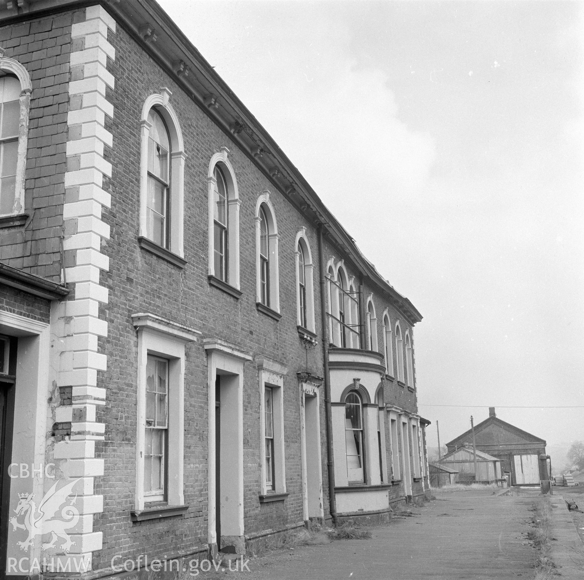 Digital copy of a black and white negative showing railtrack side elevation of Llanidloes Railway Station taken by D B Hague.