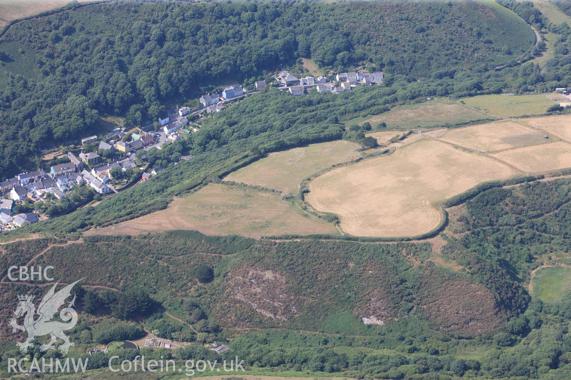 Defended enclosure and the village of Solva. Oblique aerial photograph taken during the Royal Commission?s programme of archaeological aerial reconnaissance by Toby Driver on 16th July 2013.