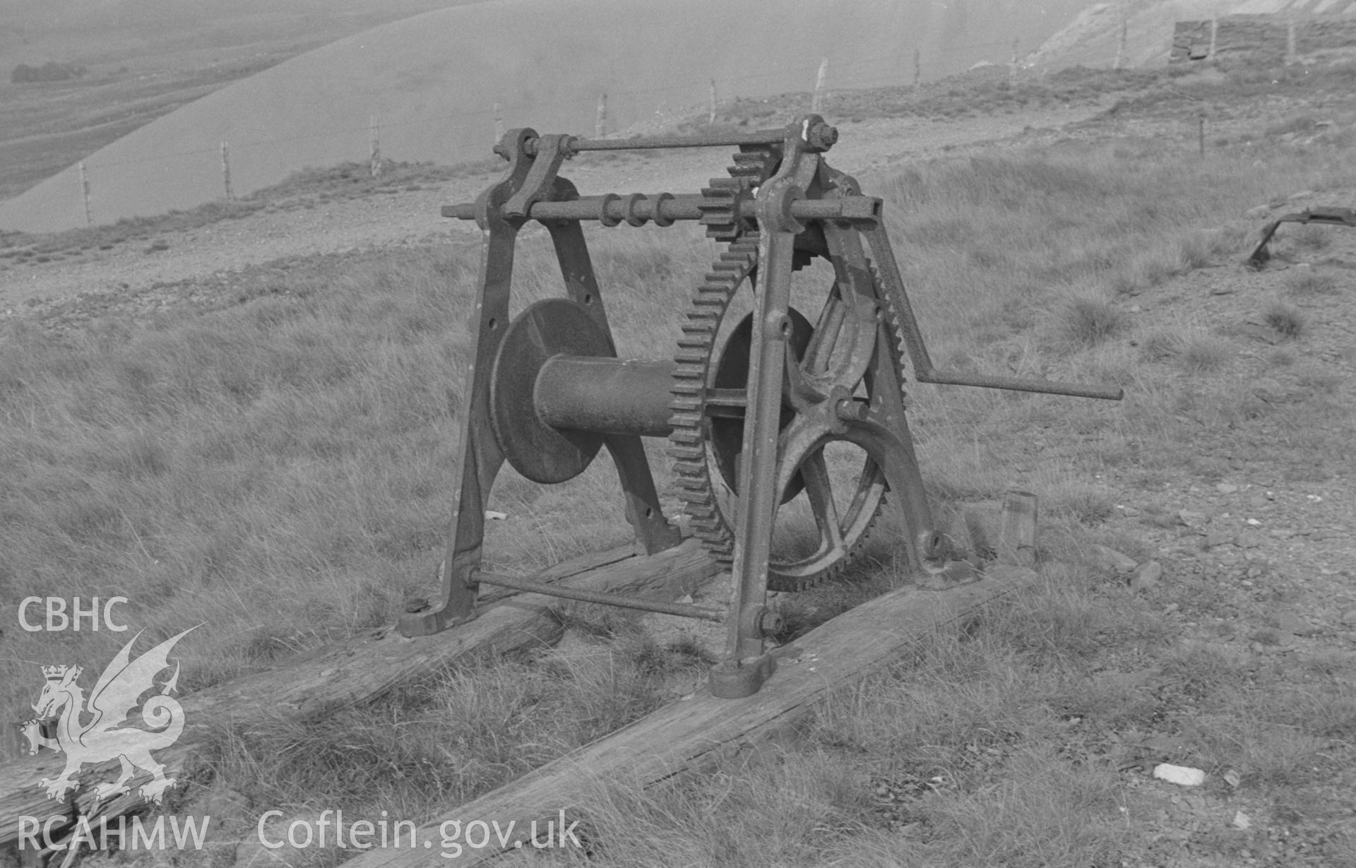 Digital copy of a black and white negative showing iron winch at head of length of wooden track at Esgair Mwyn Mine, Ystrad Fflur. Photographed by Arthur O. Chater on 28th August 1966 from Grid Reference SN 755 691.