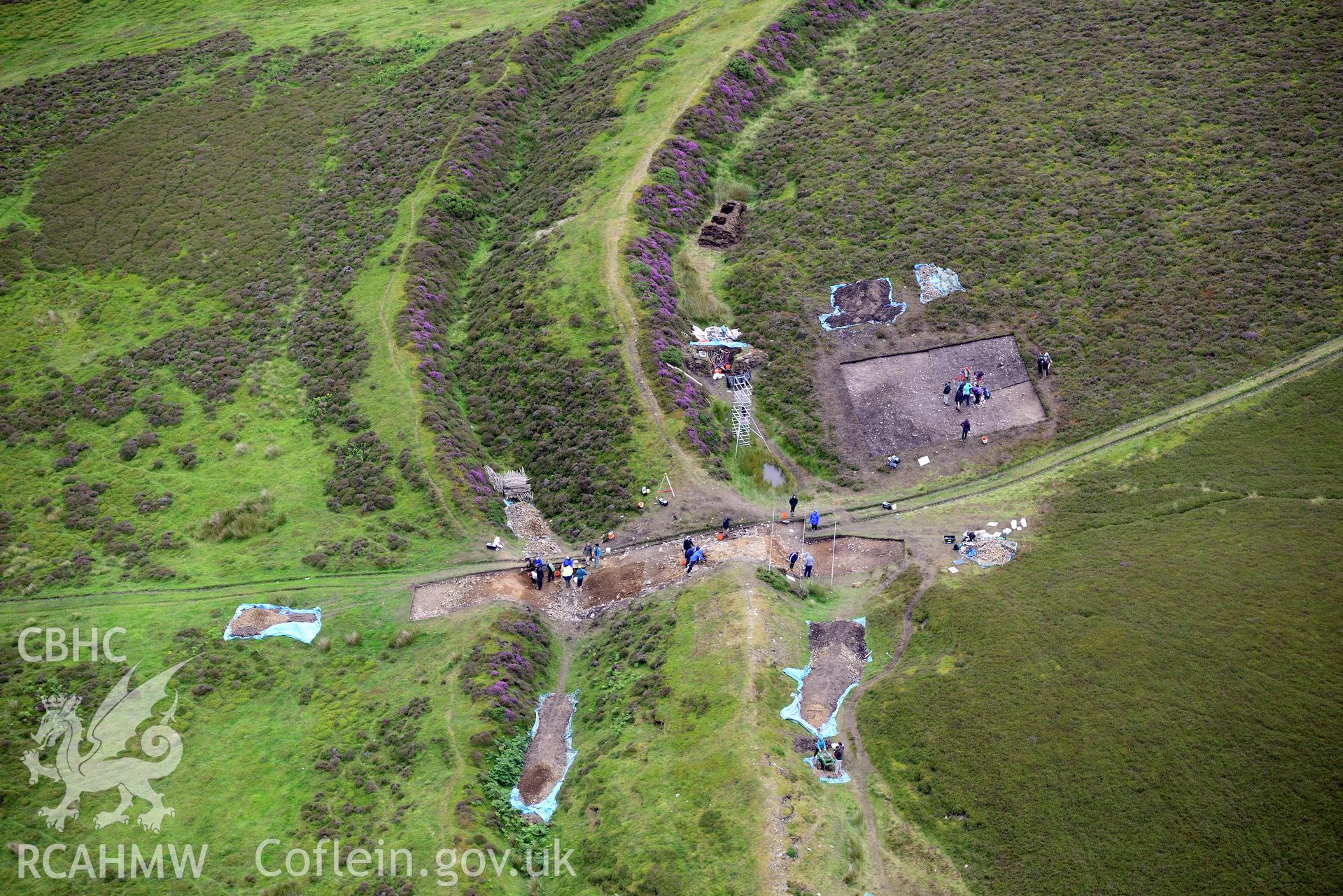 Penycloddiau Hilfort and Hut Platform V, Llangwyfan. Excavation by Liverpool University. Oblique aerial photograph taken during the Royal Commission's programme of archaeological aerial reconnaissance by Toby Driver on 30th July 2015.