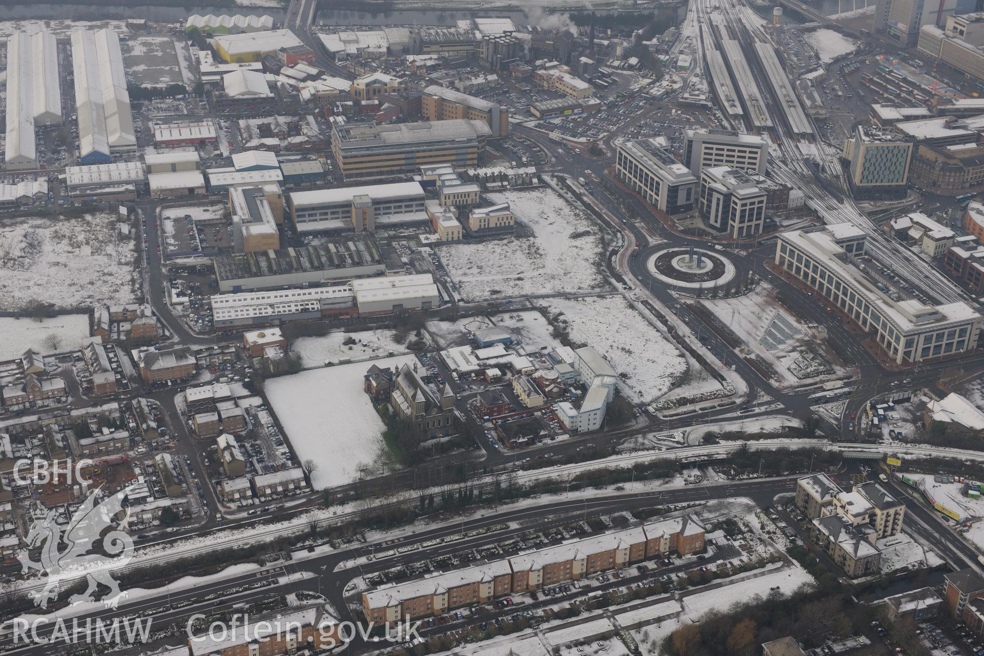 Church of St Mary the Virgin in centre of the photograph, with Cardiff Central railway station to the right. Oblique aerial photograph taken during the Royal Commission?s programme of archaeological aerial reconnaissance by Toby Driver, 24th January 2013.