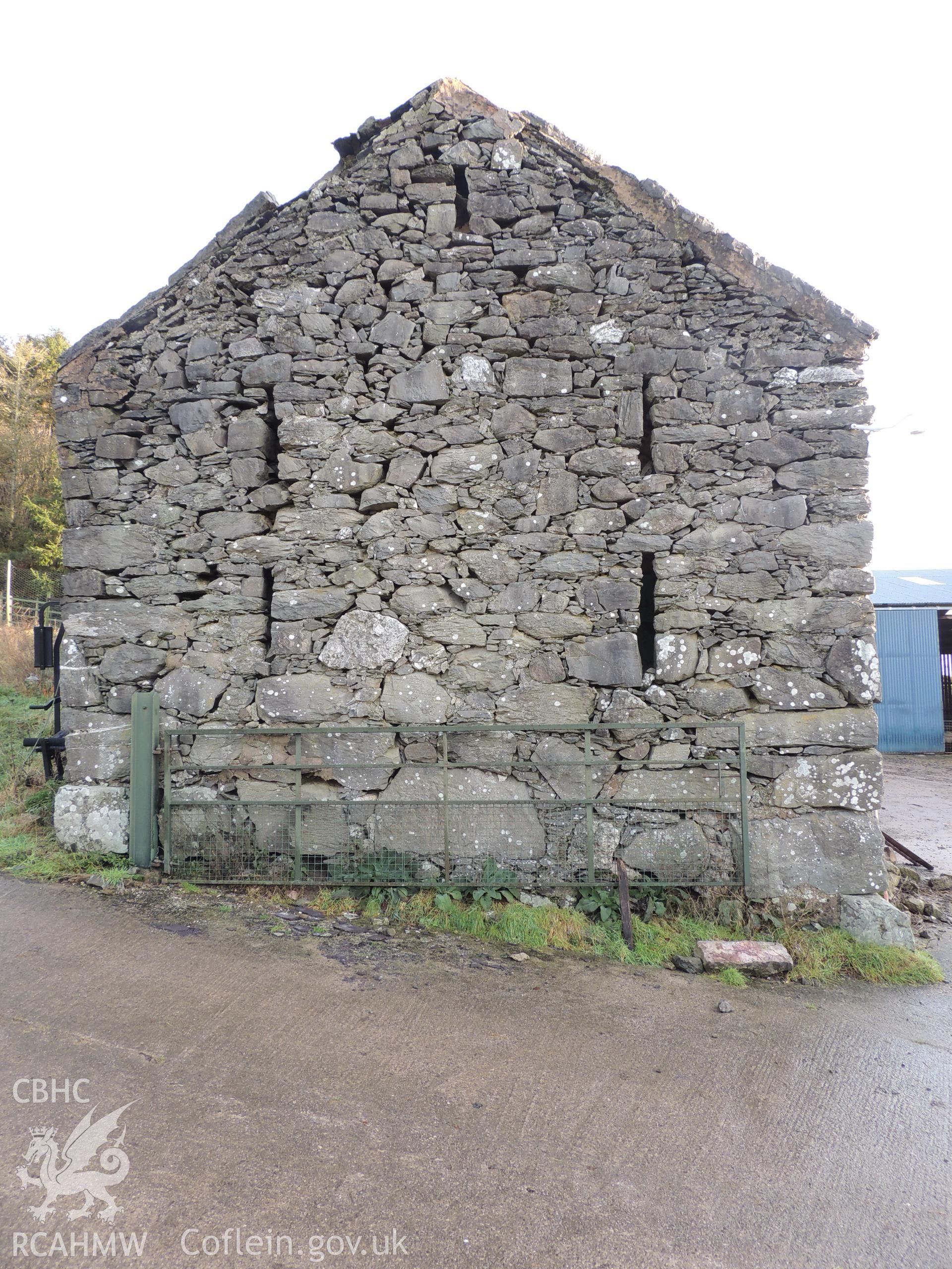 View of western elevation, looking north east. Photograph taken as part of archaeological building survey conducted at Bryn Gwylan Threshing Barn, Llangernyw, Conwy, carried out by Archaeology Wales, 2017-2018. Report no. 1640. Project no. 2578.