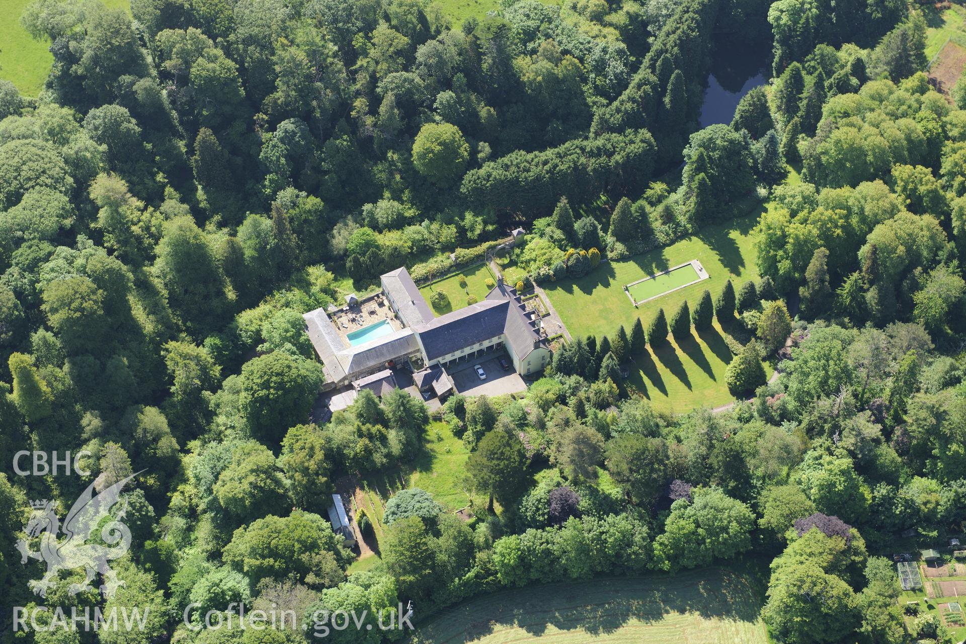 Plas Boduan surrounded by its park and gardens. Oblique aerial photograph taken during the Royal Commission's programme of archaeological aerial reconnaissance by Toby Driver on 23rd June 2015.