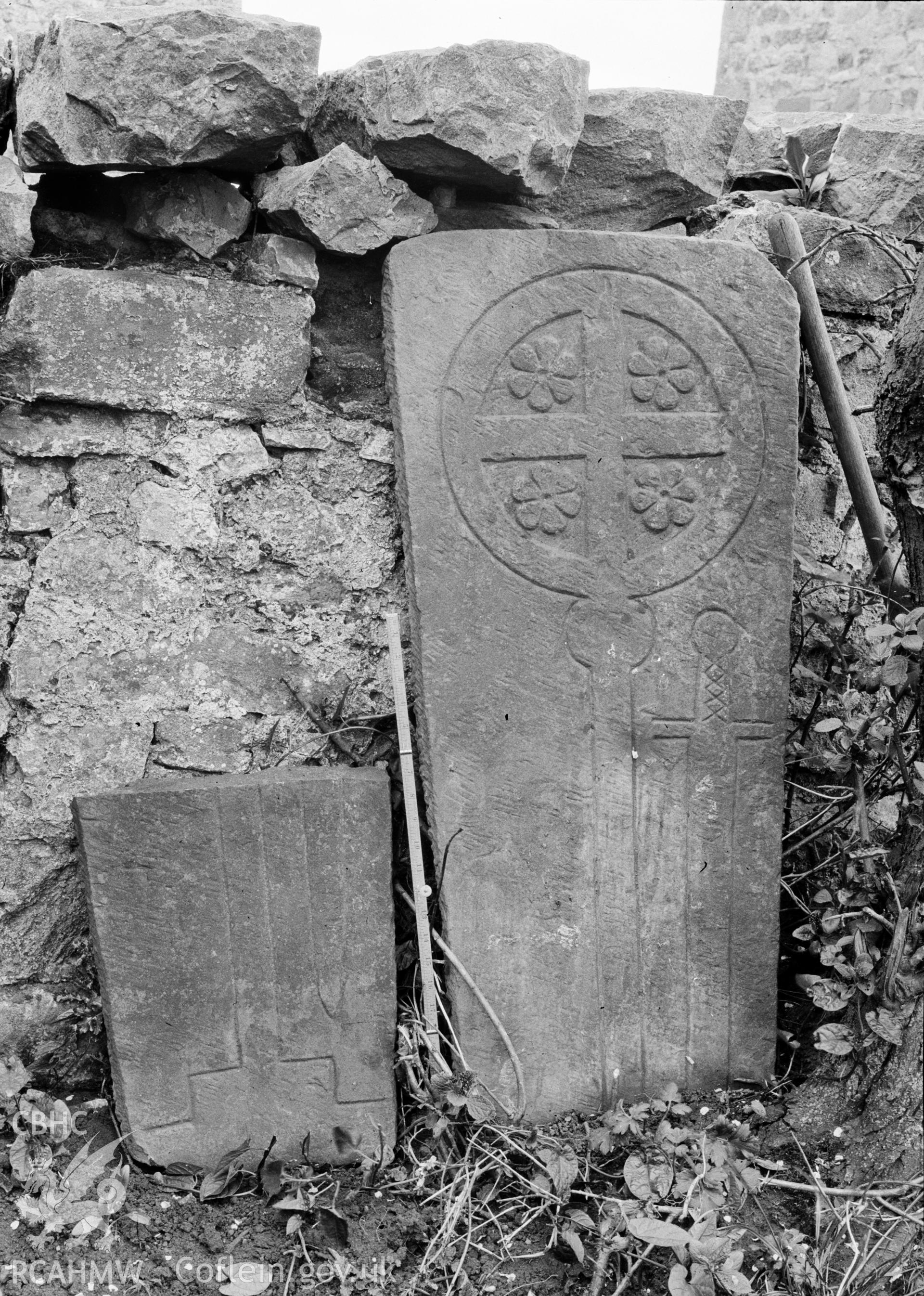 Digital copy of a nitrate negative showing view of inscribed stones in vicarage wall at the Friary near Rhuddlan Church, taken by Leonard Monroe.