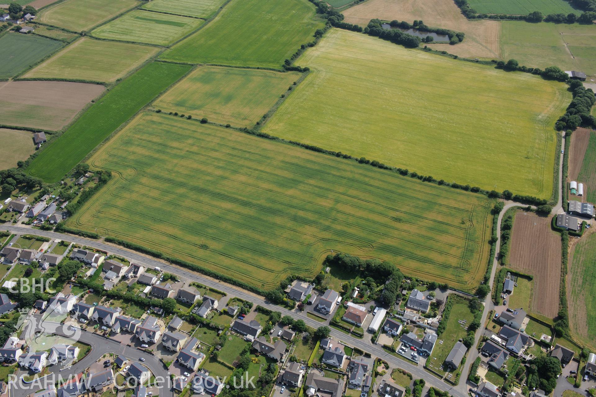 Hearson Farm defended enclosures, Hill Mountain, north east of Milford Haven. Oblique aerial photograph taken during the Royal Commission?s programme of archaeological aerial reconnaissance by Toby Driver on 16th July 2013.