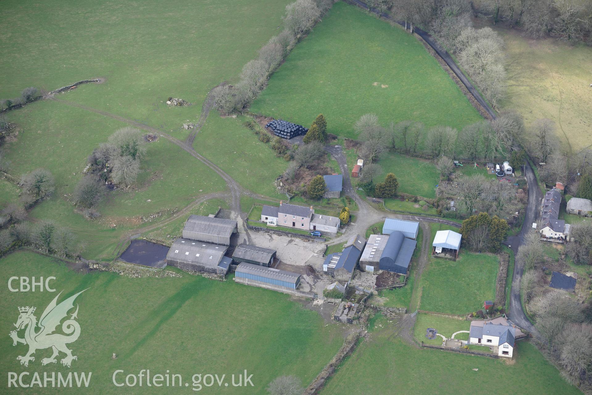 Prysg Farm & two standing stones in its southern fields with Temple Druid cottages to the north east, near Maenclochog. Oblique aerial photograph taken during Royal Commission?s programme of archaeological aerial reconnaissance by Toby Driver, 13/03/2015.