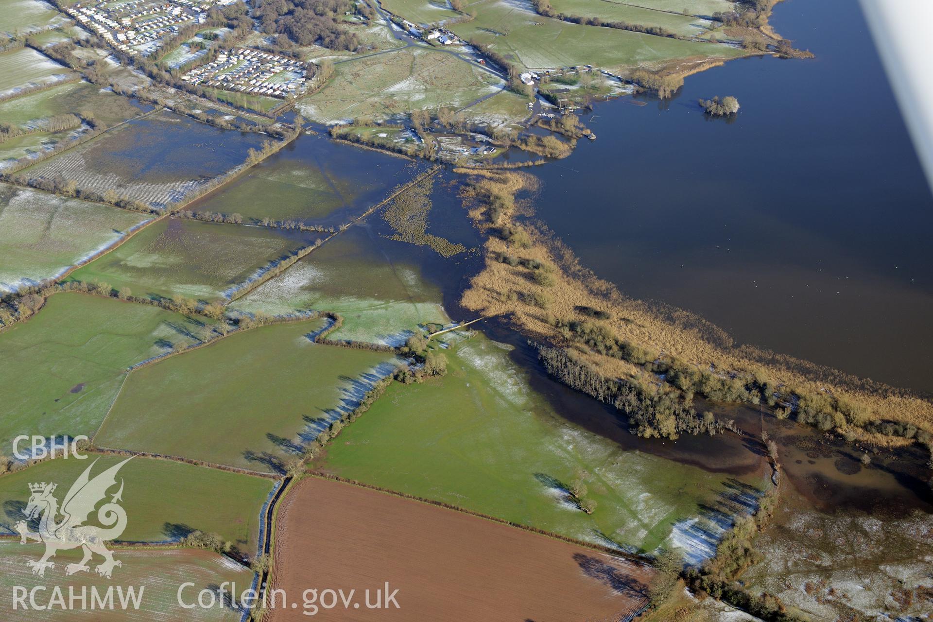 Llangros Crannog in Llangorse lake, south east of Brecon. Oblique aerial photograph taken during the Royal Commission?s programme of archaeological aerial reconnaissance by Toby Driver on 15th January 2013.