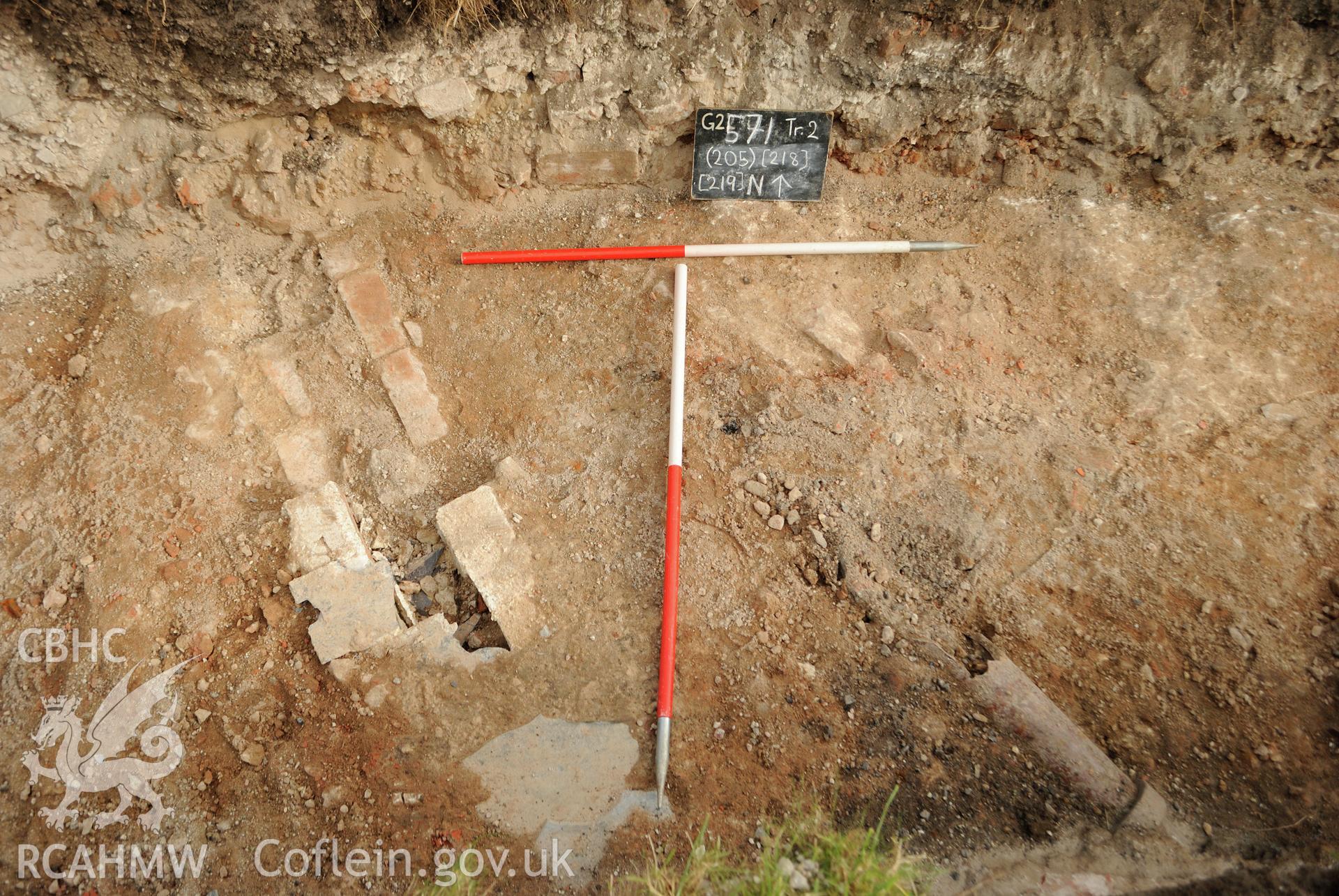 View from the south of natural subsoil, brick lined drain and ceramic pipe drain. Photographed during archaeological evaluation of Kinmel Park, Abergele, conducted by Gwynedd Archaeological Trust on 24th August 2018. Project no. 2571.