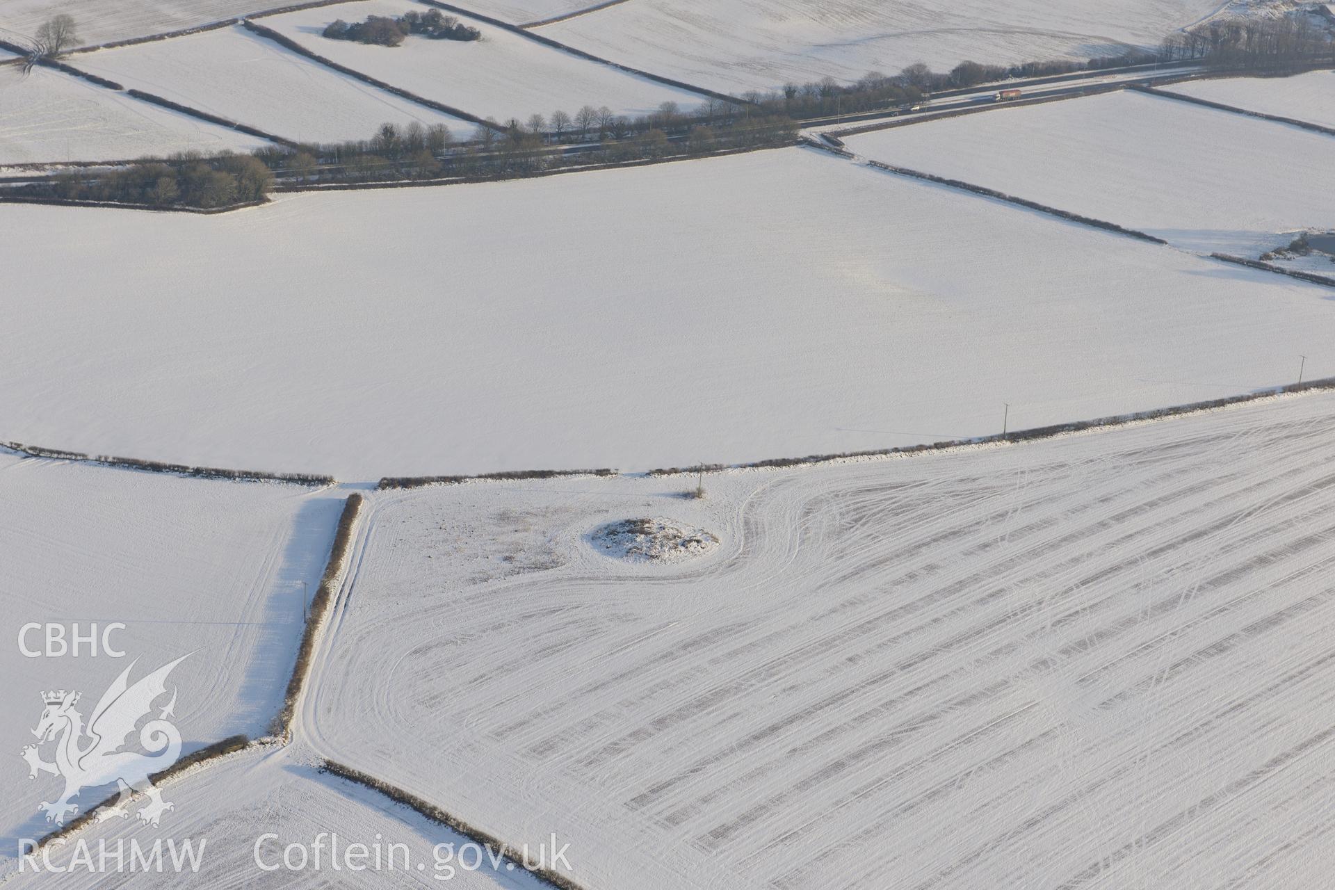 Mynydd Herbert round barrow, Merthyr Mawr, west of Bridgend. Oblique aerial photograph taken during the Royal Commission?s programme of archaeological aerial reconnaissance by Toby Driver on 24th January 2013.