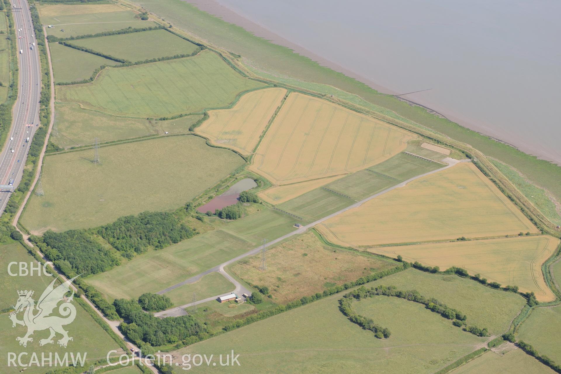 Rogiet Rifle range & section of the M4 motorway running along southern edge of Caldicot, on its way to the Second Severn Crossing. Oblique aerial photograph taken during RCAHMW?s programme of archaeological aerial reconnaissance by Toby Driver, 1 Aug 2013.