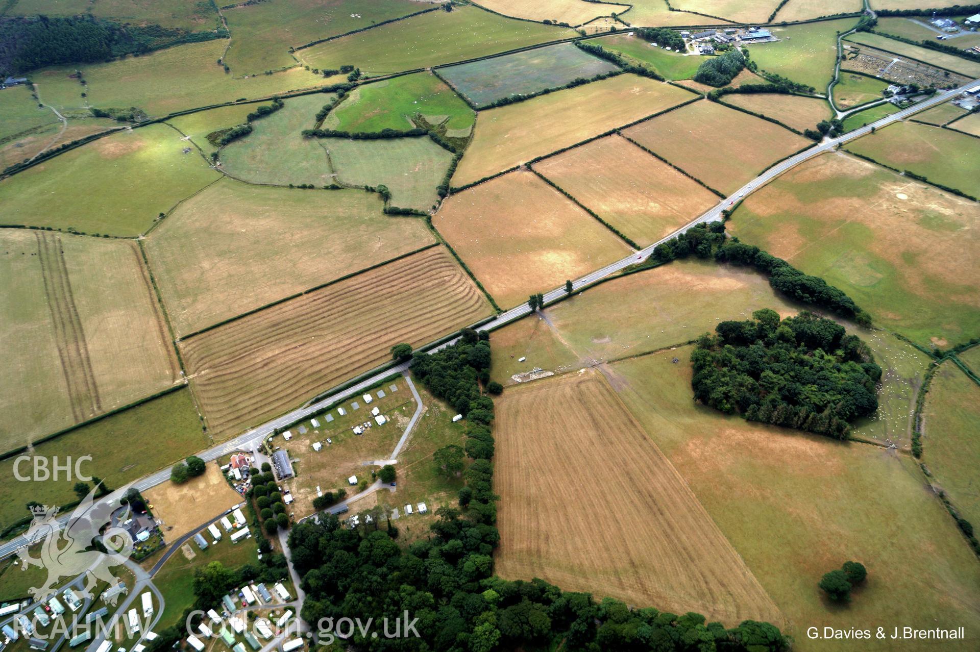 Wide shot aerial photograph of Square Barrow Cemetery & cropmarks near Ynysmaengwyn, taken by Glyn Davies & Jonathan Brentnall 16/07/2018 under drought conditions. Photograph modified to enhance visibility of archaeology. Original photograph: BDC_04_03_04.