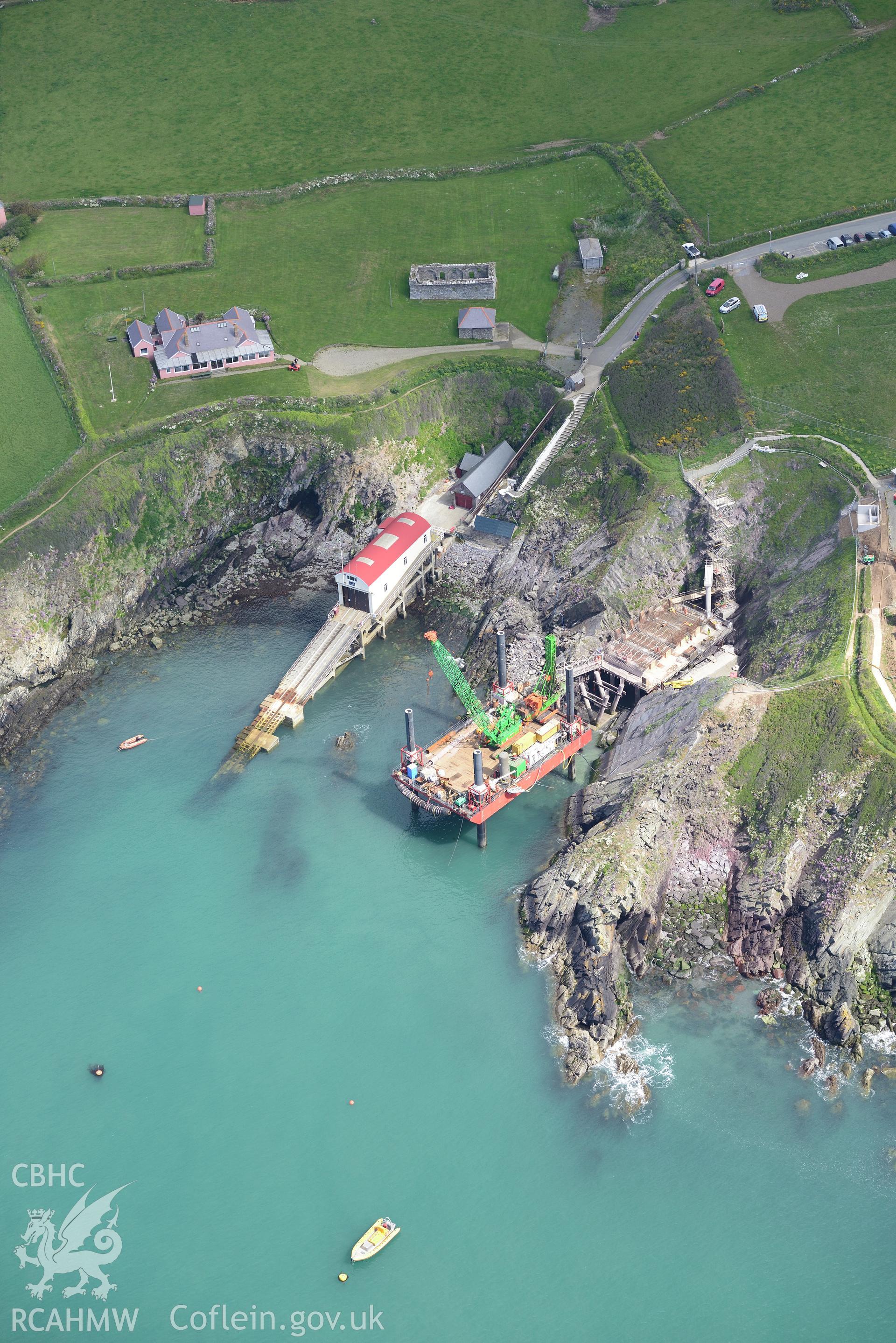 St. David's old lifeboat station with the new station under construction. The floating mooring used by the crew whilst the station was being built is also visible. Oblique aerial photograph taken during the Royal Commission's programme of archaeological aerial reconnaissance by Toby Driver on 13th May 2015.