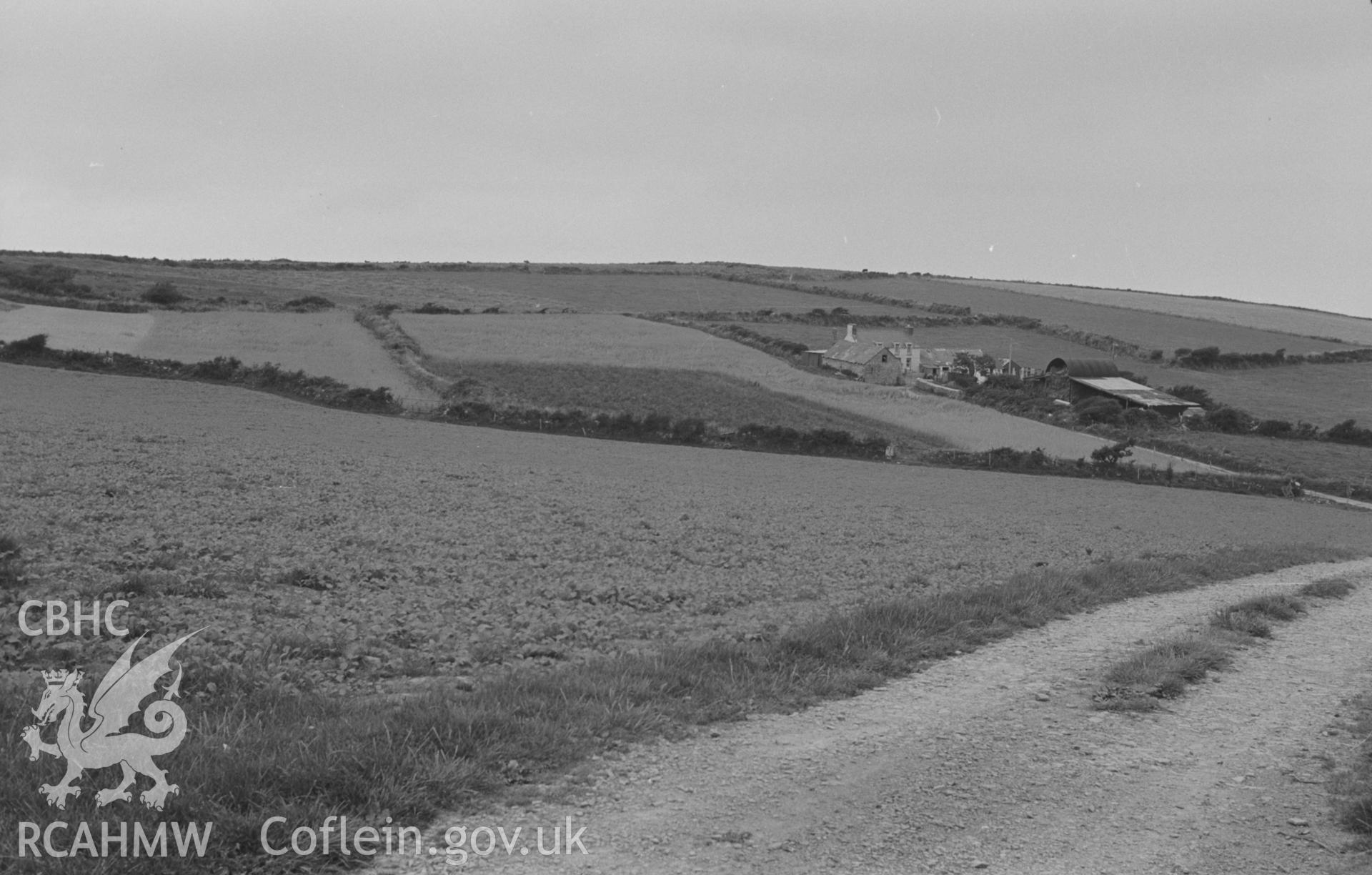 Digital copy of a black and white negative showing Gaer-wen farm and pre-Roman Iron Age farmstead (extreme left), 4km north east of Llangrannog. Photographed by Arthur O. Chater in August 1967. (Looking north from Grid Reference SN 346 561)