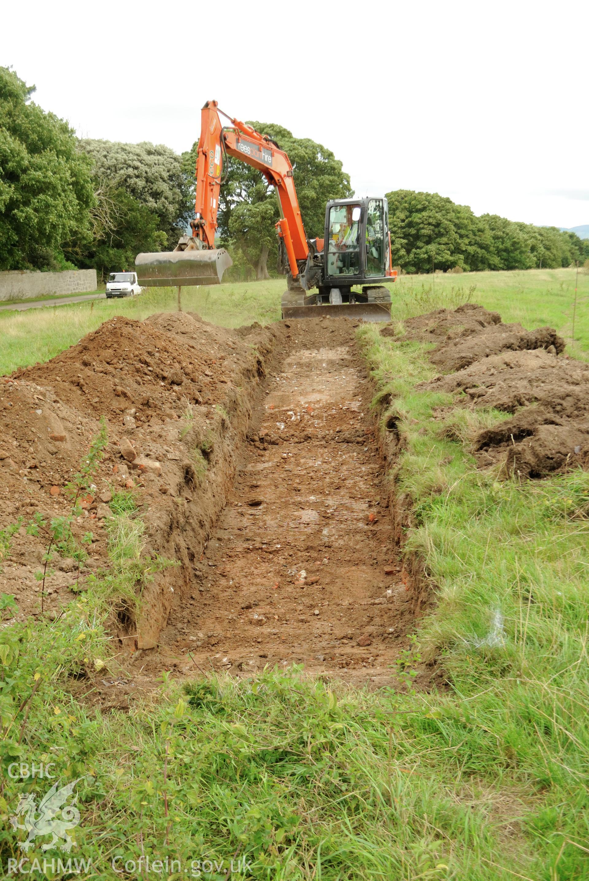 View from west showing excavation of trench 1. Photographed during archaeological evaluation of Kinmel Park, Abergele, conducted by Gwynedd Archaeological Trust on 22nd August 2018. Project no. 2571.