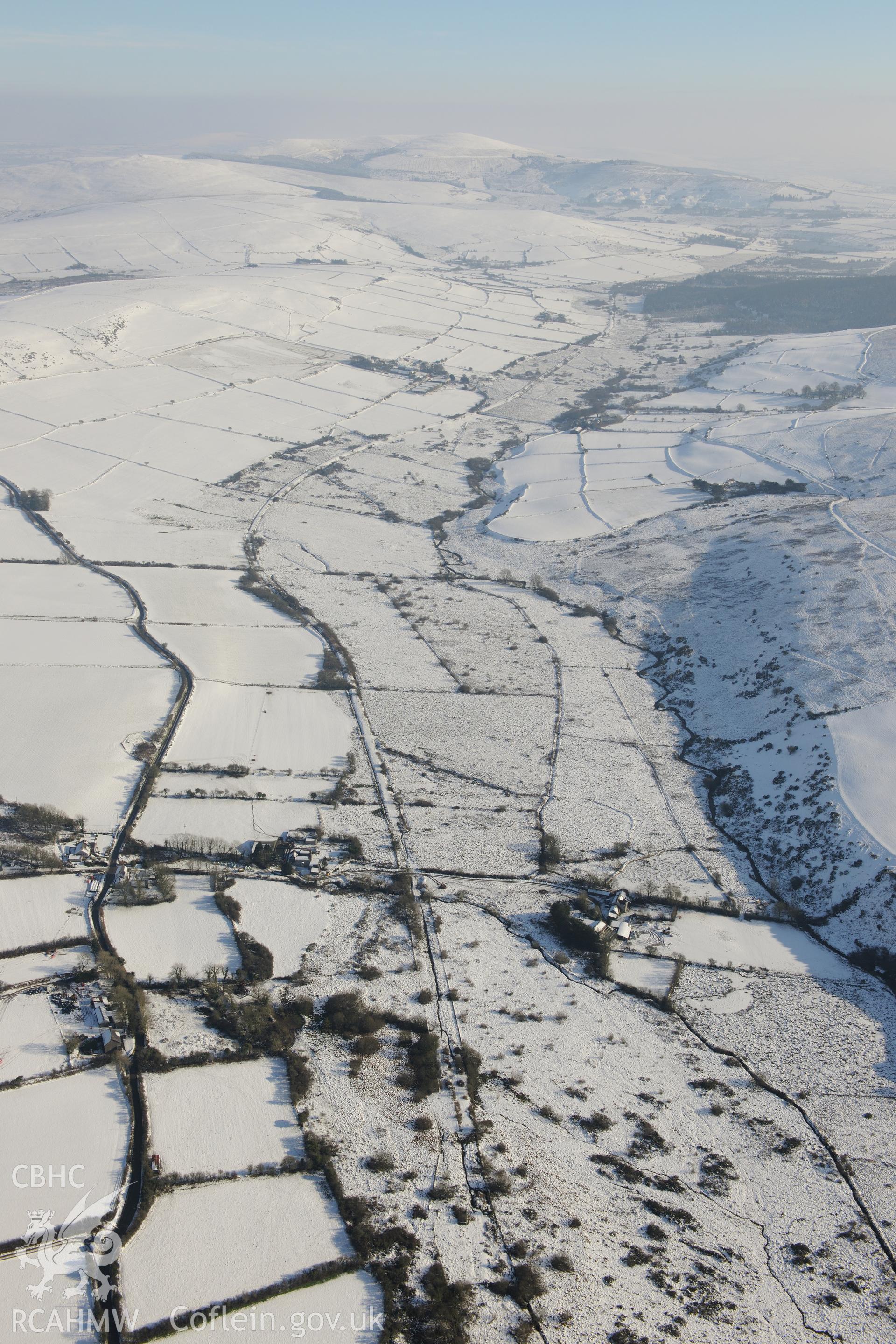 Landscape around St John the Baptist's church, Morvil, Puncheston, in the foothills of the Preseli mountains. Oblique aerial photograph taken during the Royal Commission?s programme of archaeological aerial reconnaissance by Toby Driver on 24th January 2013.