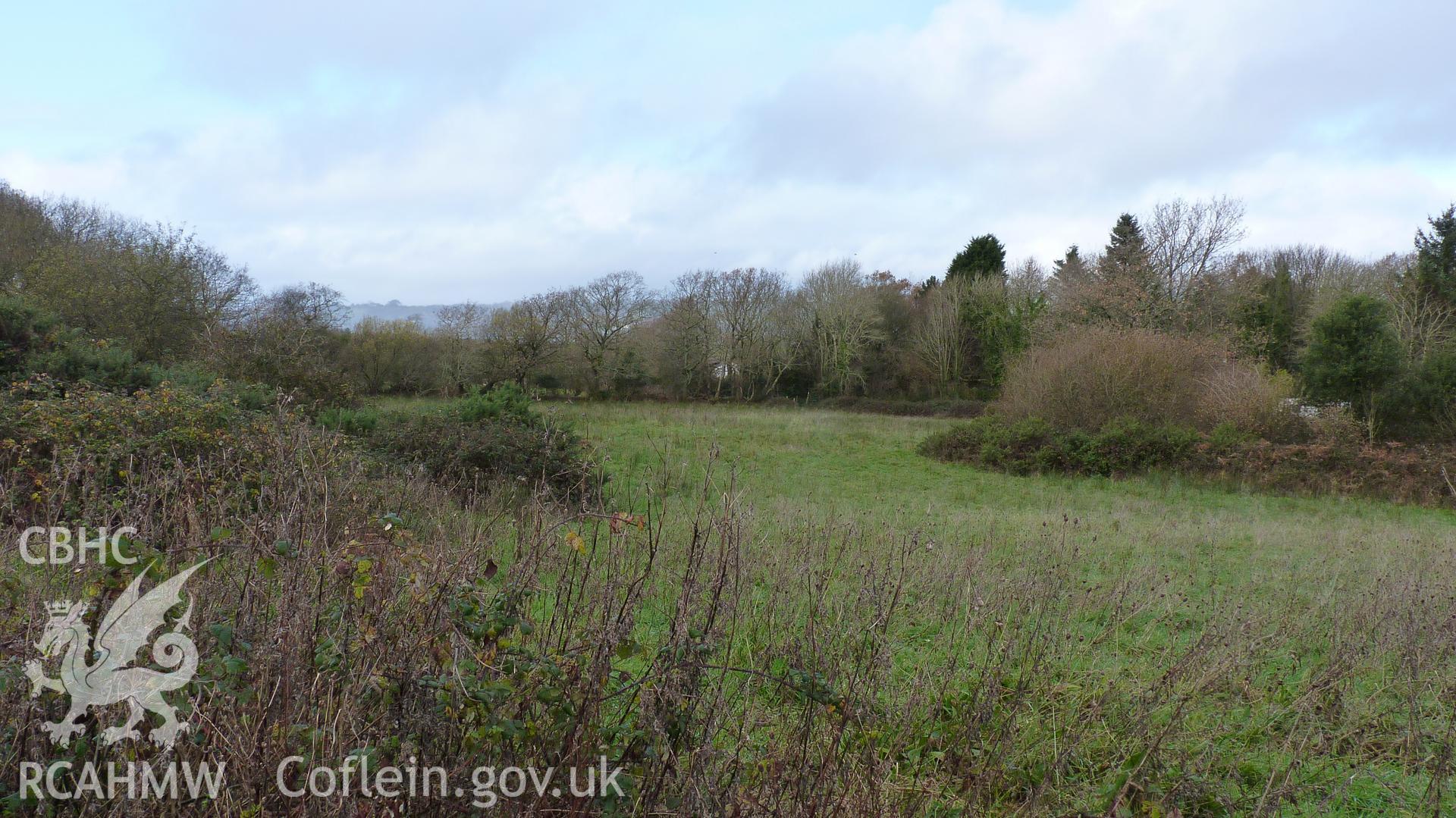 View from the site looking east at the neighbouring works, and area of 19th century quarry. Photographed as part of desk based assessment of land off Heol Pentre Bach, Gorseinon, conducted by Archaeology Wales on 5th December 2017.