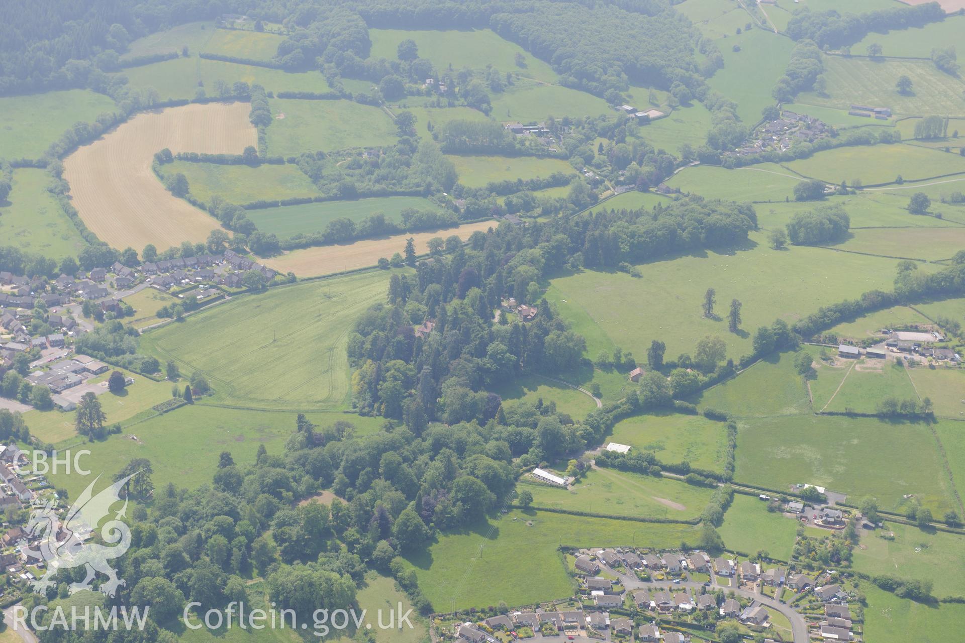 Prestigne town and Sila House (in the trees). Oblique aerial photograph taken during the Royal Commission's programme of archaeological aerial reconnaissance by Toby Driver on 11th June 2015.