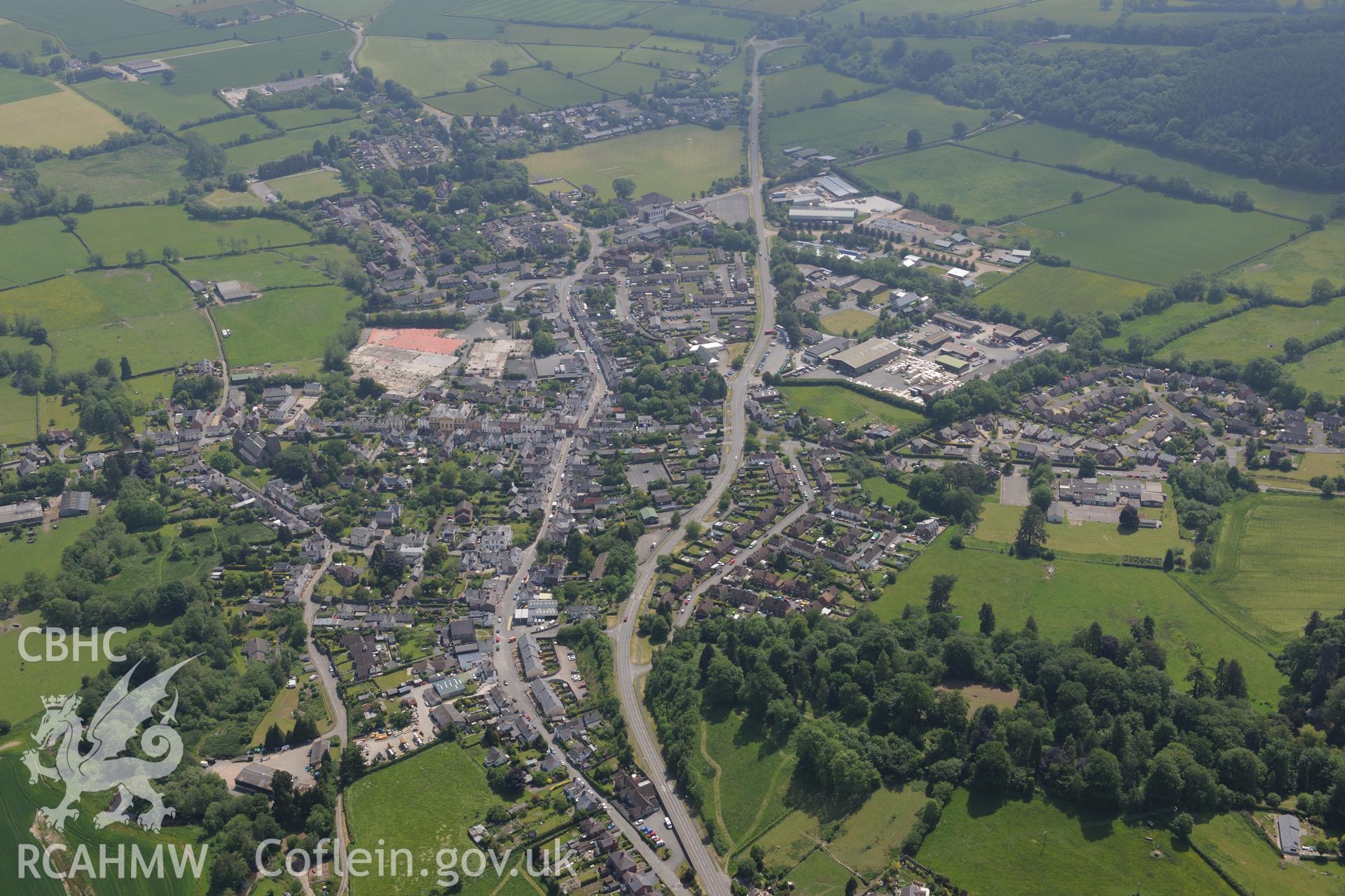 Prestigne town and Prestigne castle. Oblique aerial photograph taken during the Royal Commission's programme of archaeological aerial reconnaissance by Toby Driver on 11th June 2015.