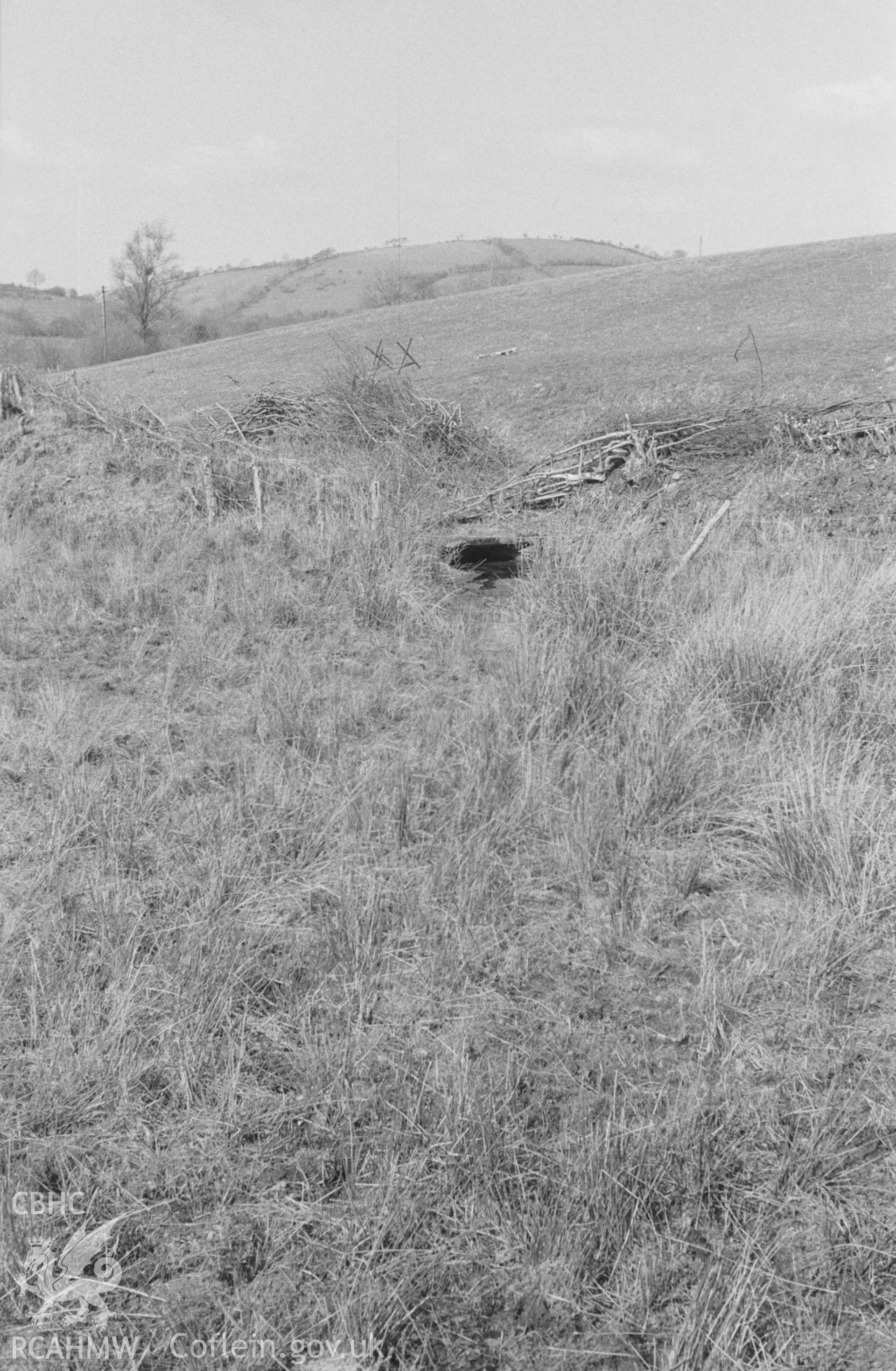 Digital copy of a black and white negative showing Ffynnon Gybi holy well at Llangybi (Ceredigion). Formerly roofed over, with seats and a bath; resorted to for rheumatism and skin diseases. Photographed by Arthur O. Chater in April 1966 from SN 605 528.