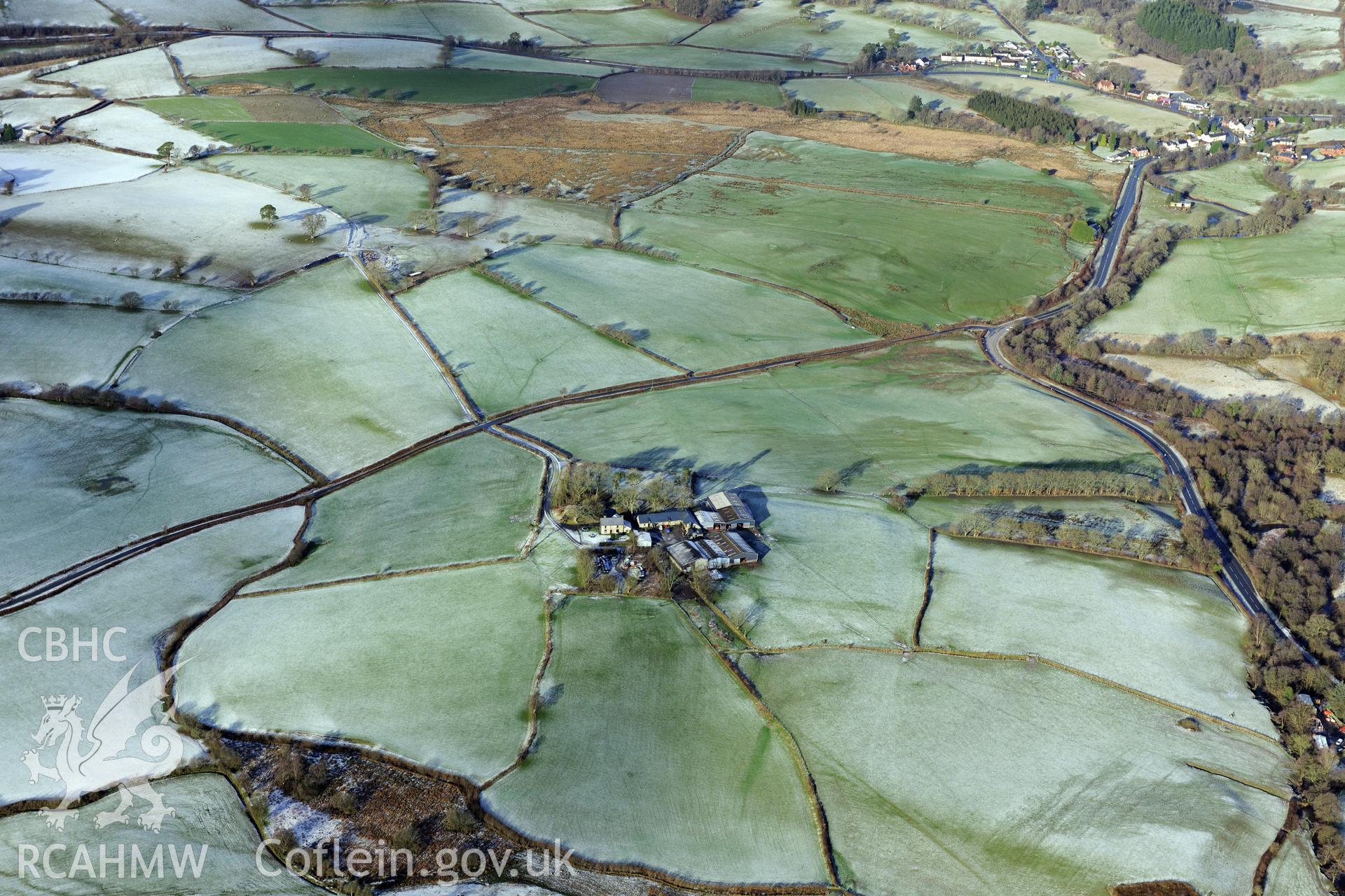 Beulah village, Twdin Motte, Caerau Roman fort & military settlement, and Roman road from Carmarthen to Castell Collen (RR623). Oblique aerial photograph taken during RCAHMW?s programme of archaeological aerial reconnaissance by Toby Driver 15/01/2013.