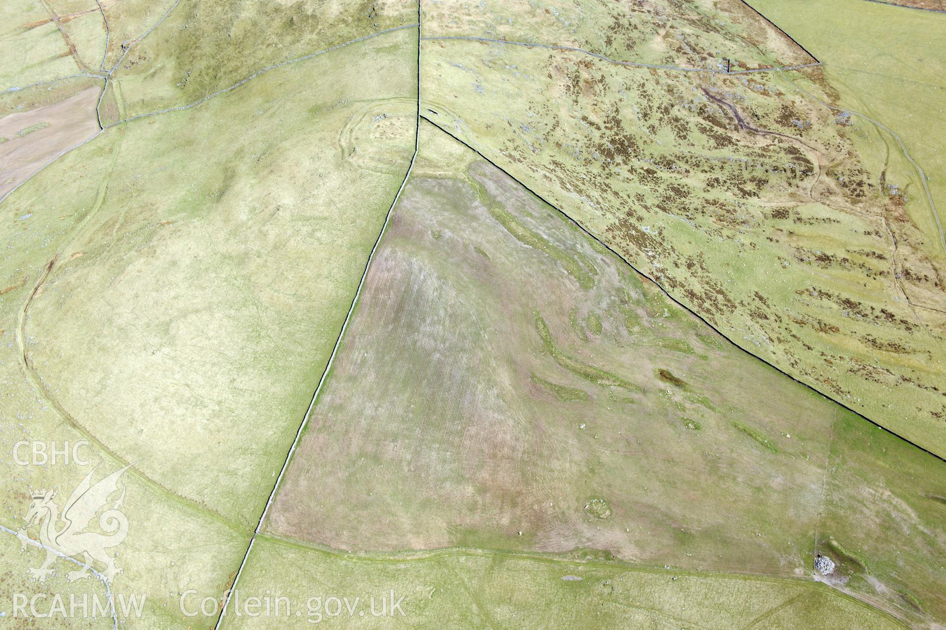 Hill fort, cairn circles and hut circle at Moel Goedog, Harlech. Oblique aerial photograph taken during the Royal Commission?s programme of archaeological aerial reconnaissance by Toby Driver on 1st May 2013.