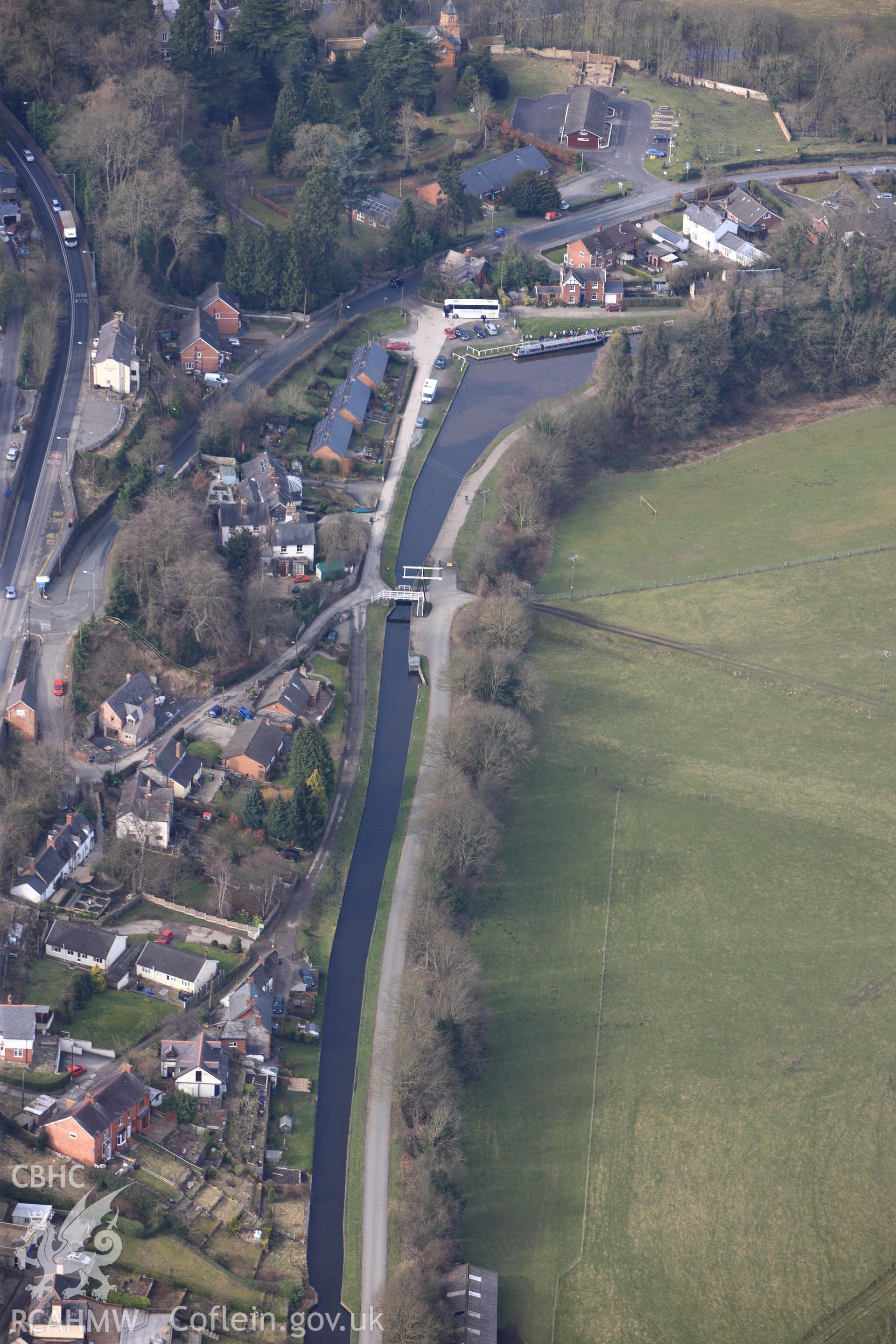 Fron footbridge, lifting bridge, basin culvert no. 96 and basin on the Llagollen Canal in Froncysyllte, south east of Llangollen. Oblique aerial photograph taken during the Royal Commission?s programme of archaeological aerial reconnaissance by Toby Driver on 28th February 2013.