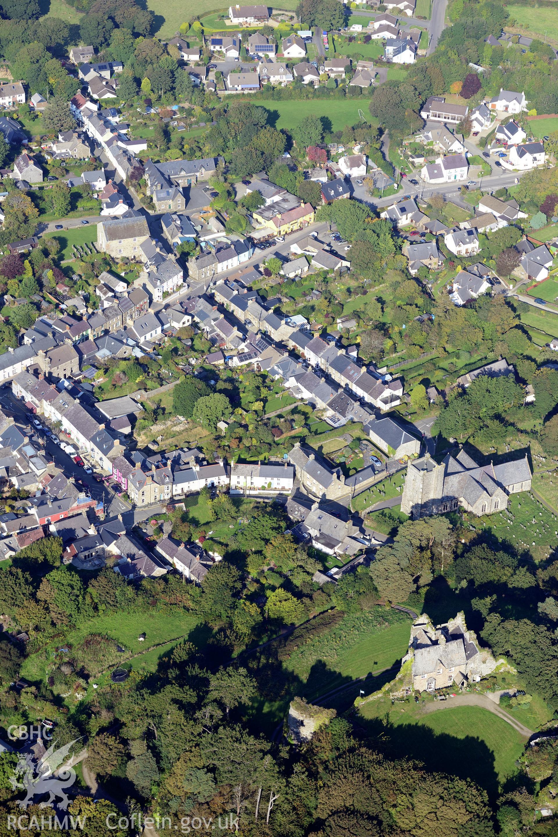 Newport Castle and St. Mary's Church in the town of Newport, Pembrokeshire. Oblique aerial photograph taken during the Royal Commission's programme of archaeological aerial reconnaissance by Toby Driver on 30th September 2015.