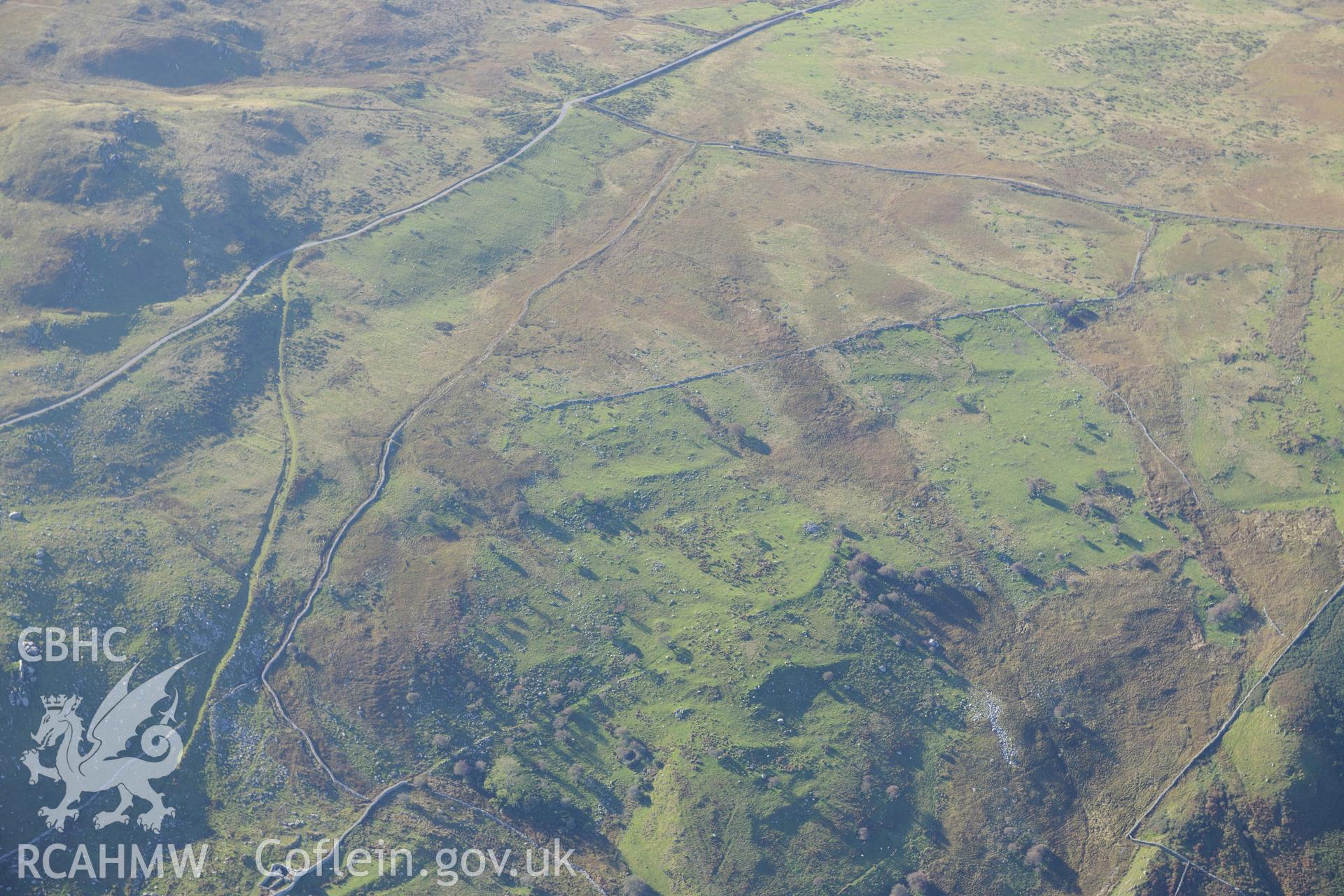 An enclosure at Morfa and hut circles south east of Mynydd Craig Wen, near Fairbourne. Oblique aerial photograph taken during the Royal Commission's programme of archaeological aerial reconnaissance by Toby Driver on 2nd October 2015.