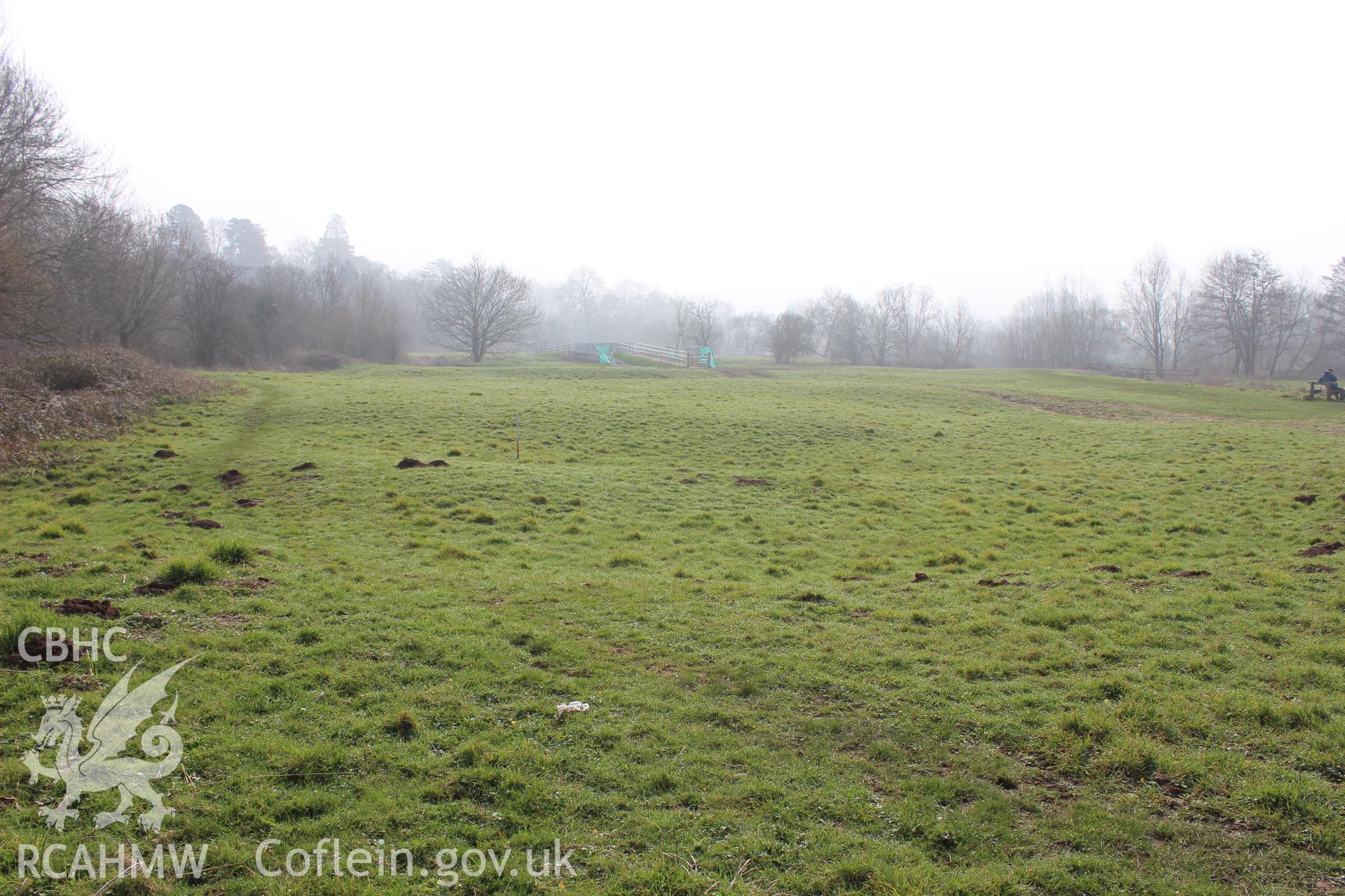 'Earthworks (possible riverine) west of the Gafenni-Usk confluence (looking west).' Photographed on site visit for desk based assessment of the proposed Eisteddfod Site at Castle Meadows and Llanfoist, Abergavenny, carried out by Archaeology Wales, 2014.