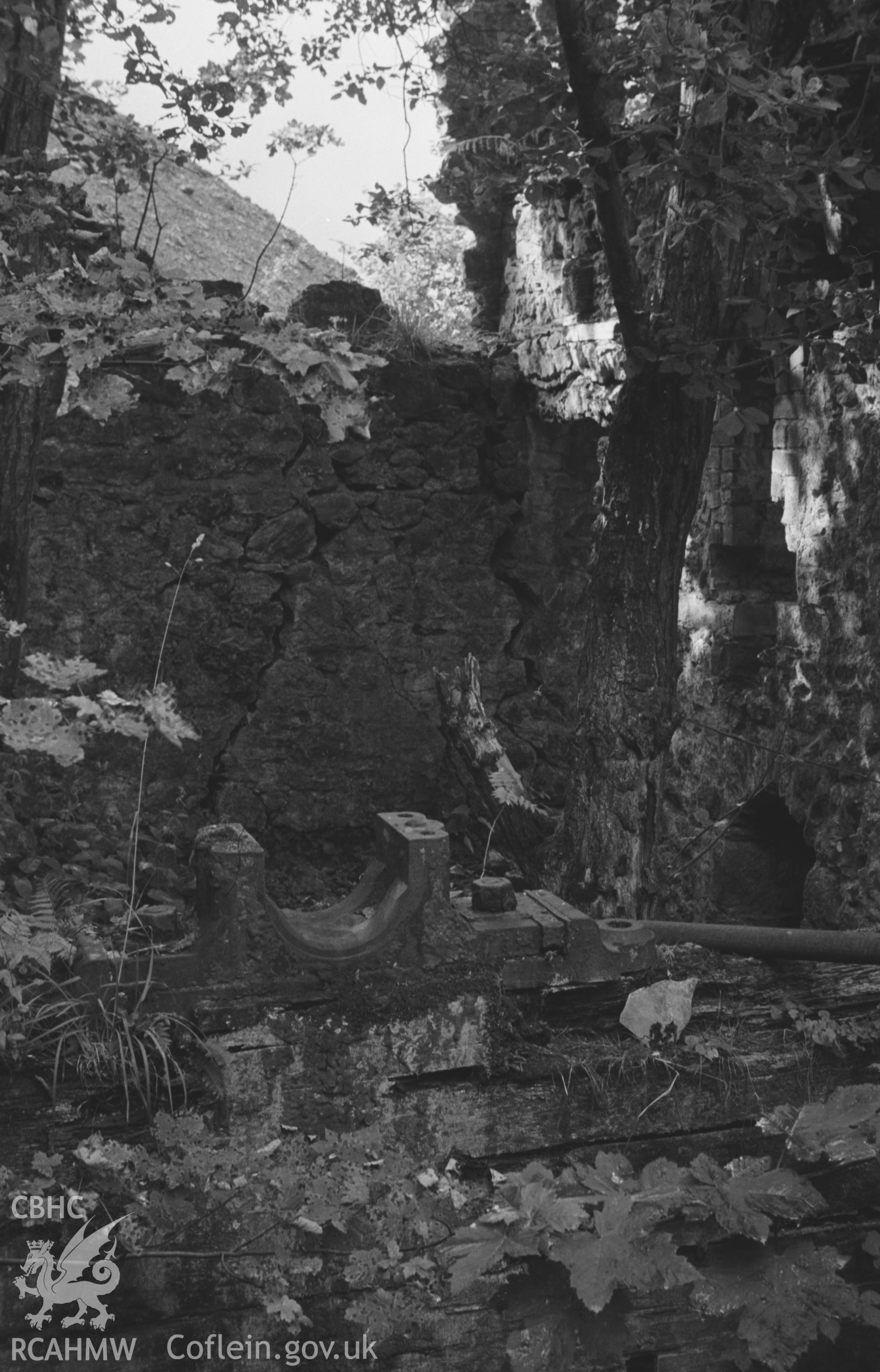 Digital copy of a black and white negative showing the large wheel pit in the ruins of the main building at Bronfloyd Lead Mine, showing the iron sockets for the axle of the wheel. Photographed by Arthur O. Chater in August 1966 from Grid Ref SN 661 836.