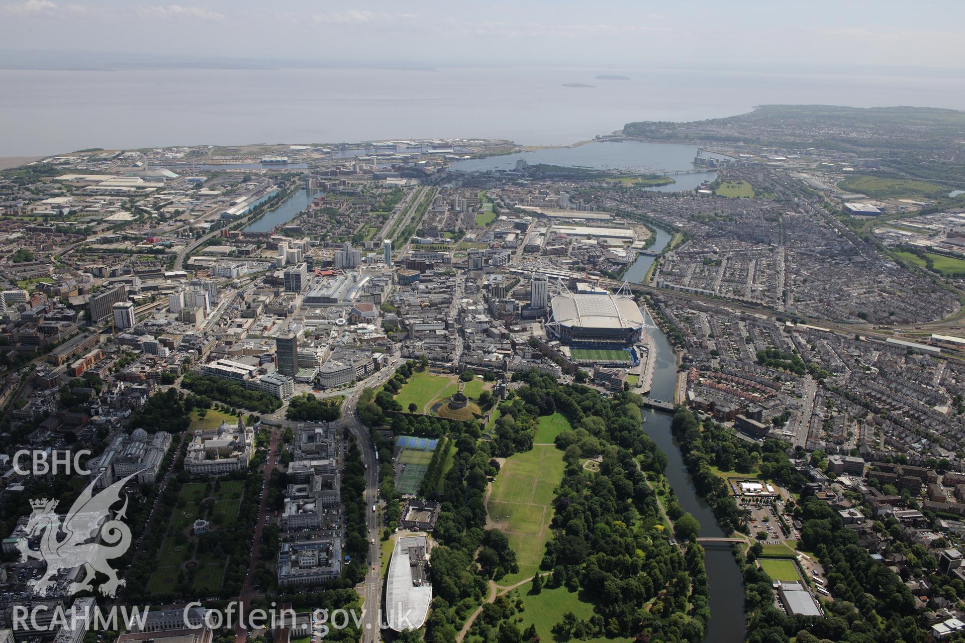 Views of Cardiff including the Bay, Millennium Stadium, Castle and grounds and Welsh College of Music and Drama. Oblique aerial photograph taken during the Royal Commission's programme of archaeological aerial reconnaissance by Toby Driver on 29/6/2015.