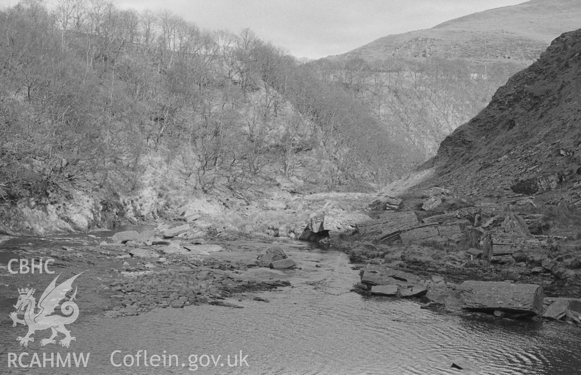 Digital copy of a black and white negative showing view looking down the Rheidol from 1.2km below Ponterwyd; aqueduct to Parson's Bridge mine goes off from centre of picture. Photographed in April 1964 by Arthur O. Chater from Grid Reference SN 752 798.