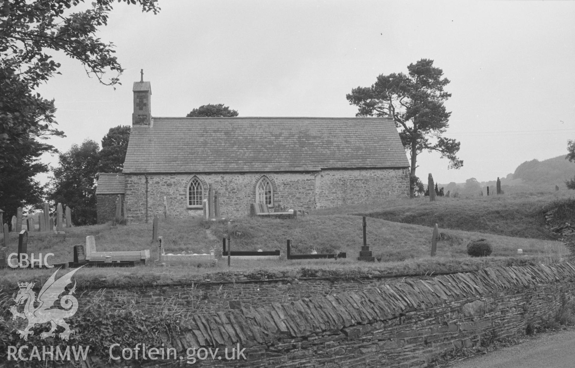 Digital copy of a black and white negative showing exterior view of St. Cybi's church, Llangybi (Ceredigion). Photographed by Arthur O. Chater in August 1965 from the main road (Grid Reference SN 6088 5312), looking north north west.