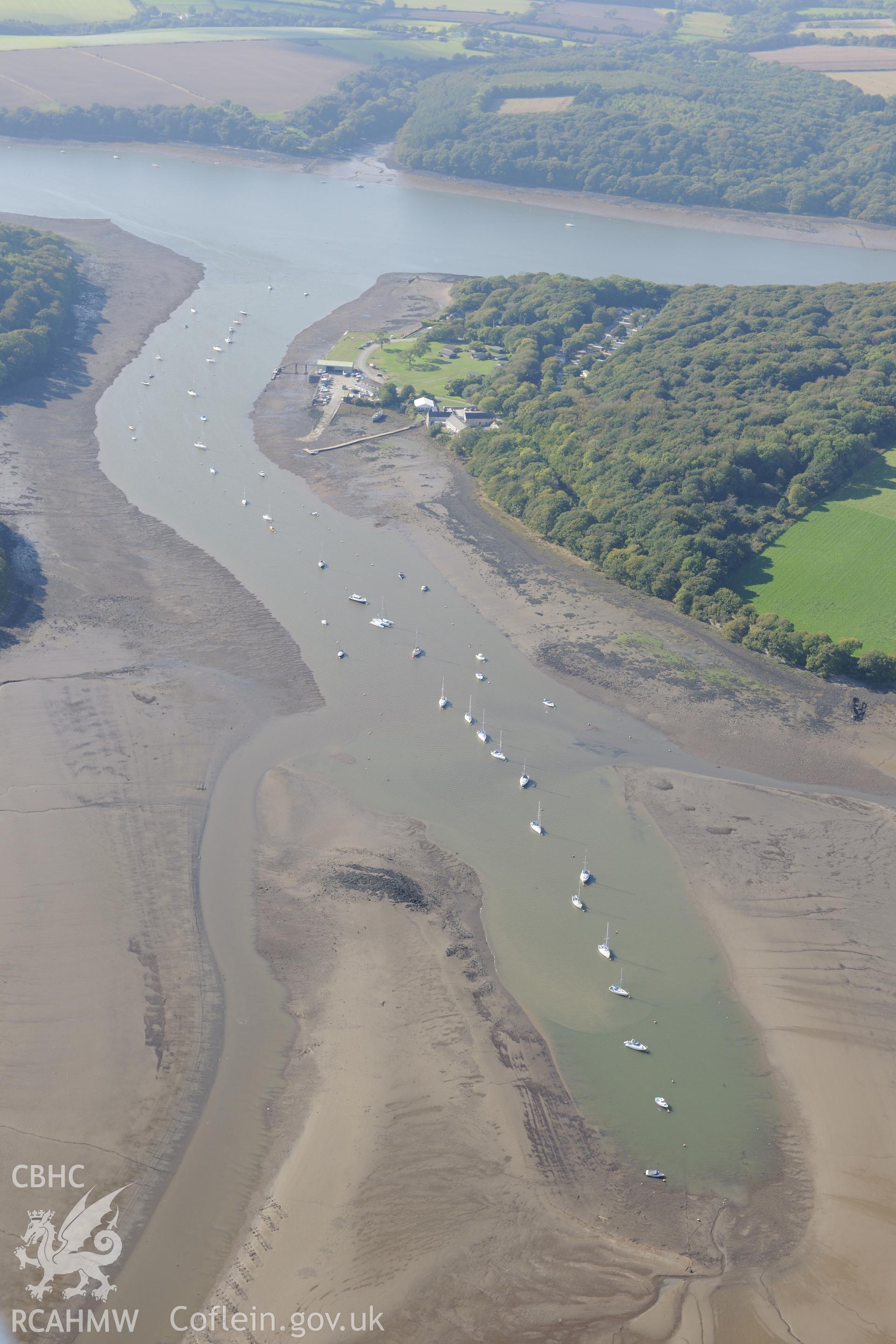 The village of Lawrenny and its quay, on the banks of the Daugleddau river, north east of Pembroke dock. Oblique aerial photograph taken during the Royal Commission?s programme of archaeological aerial reconnaissance by Toby Driver on 30th September 2015.