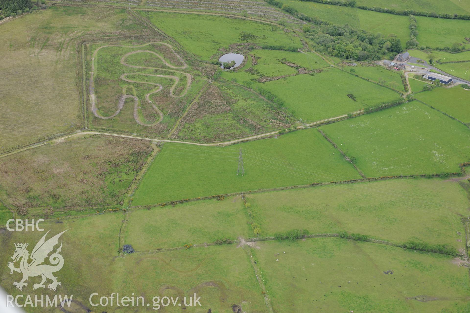 Cructarw round barrow and cube, Llangeler. Oblique aerial photograph taken during the Royal Commission's programme of archaeological aerial reconnaissance by Toby Driver on 3rd June 2015.