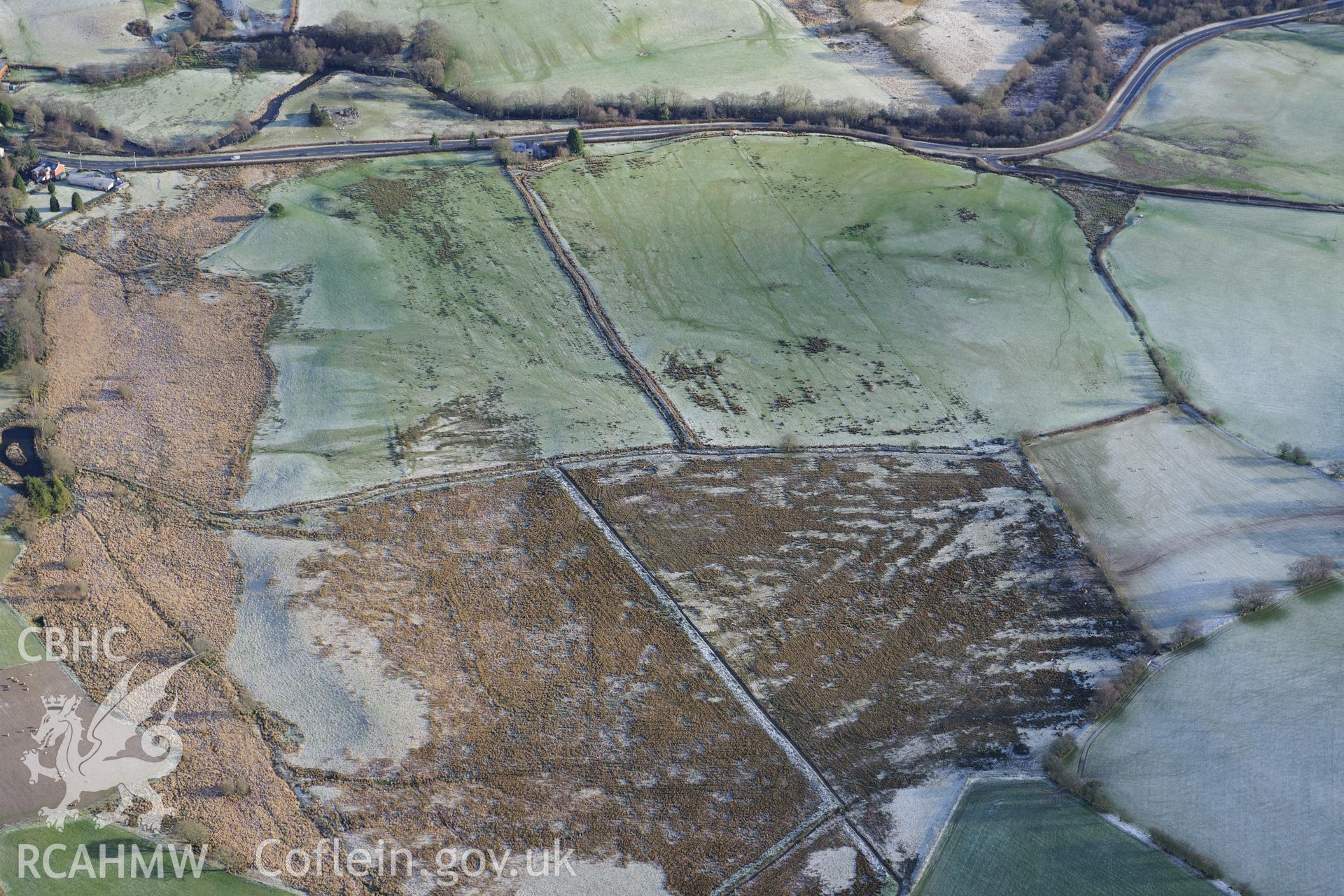 Roman camps north of Caerau and an earthwork enclosure north-west of Caerau and south of Beulah village, west of Builth Wells. Oblique aerial photograph taken during the Royal Commission?s programme of archaeological aerial reconnaissance by Toby Driver on 15th January 2013.