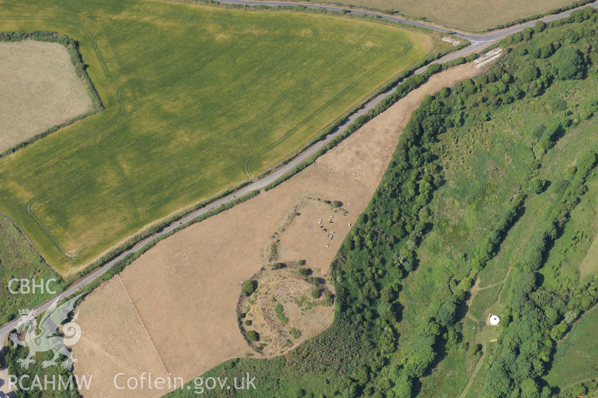 Parc-y-Castell Ringworks at Bishops Castle, St Davids. Oblique aerial photograph taken during the Royal Commission?s programme of archaeological aerial reconnaissance by Toby Driver on 16th July 2013.