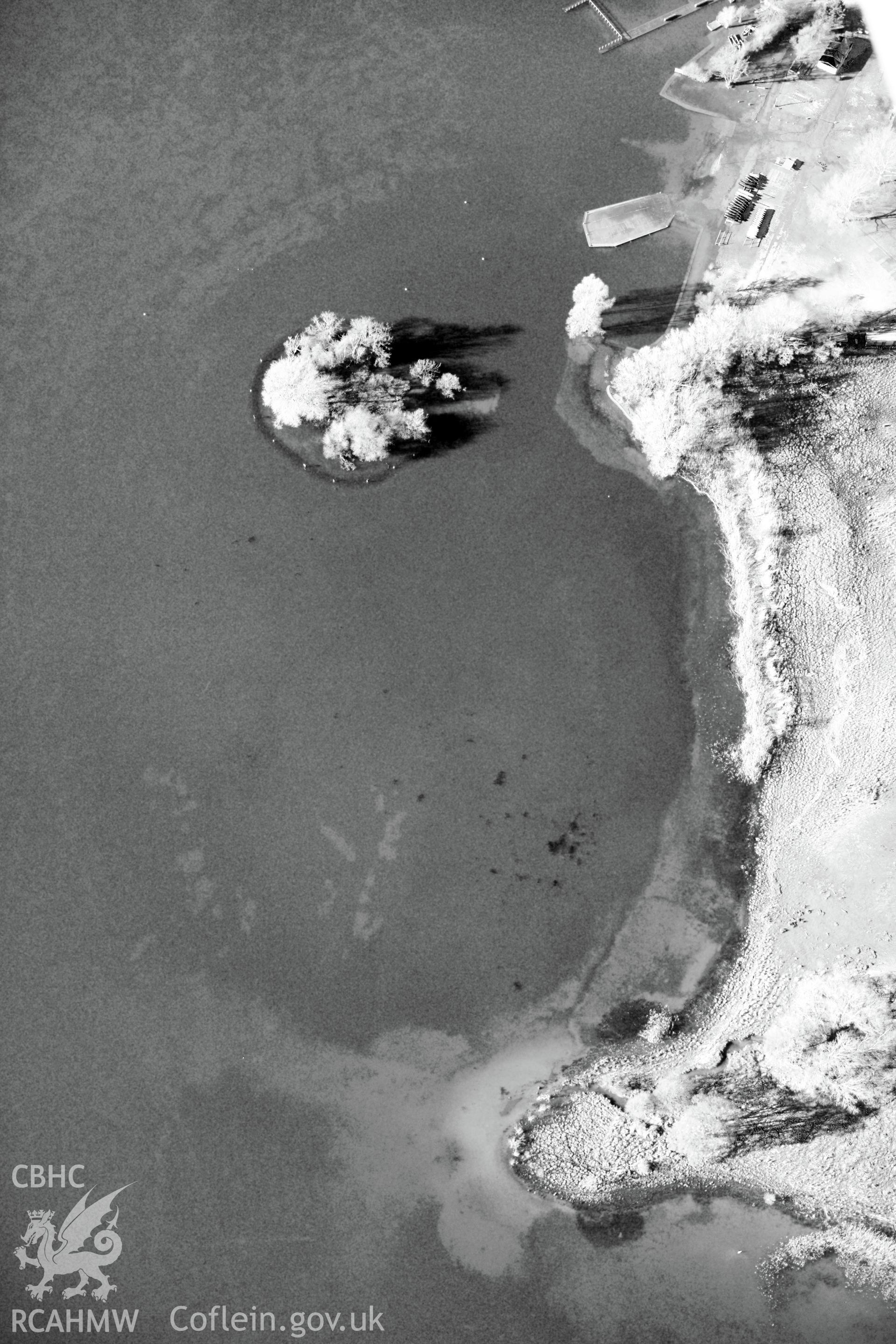 The Welsh Crannog Centre on the shores of Llangorse lake and Llangors Crannog in Llangorse lake, south east of Brecon. Oblique aerial photograph taken during Royal Commission?s programme of archaeological aerial reconnaissance by Toby Driver on 15/01/2013.