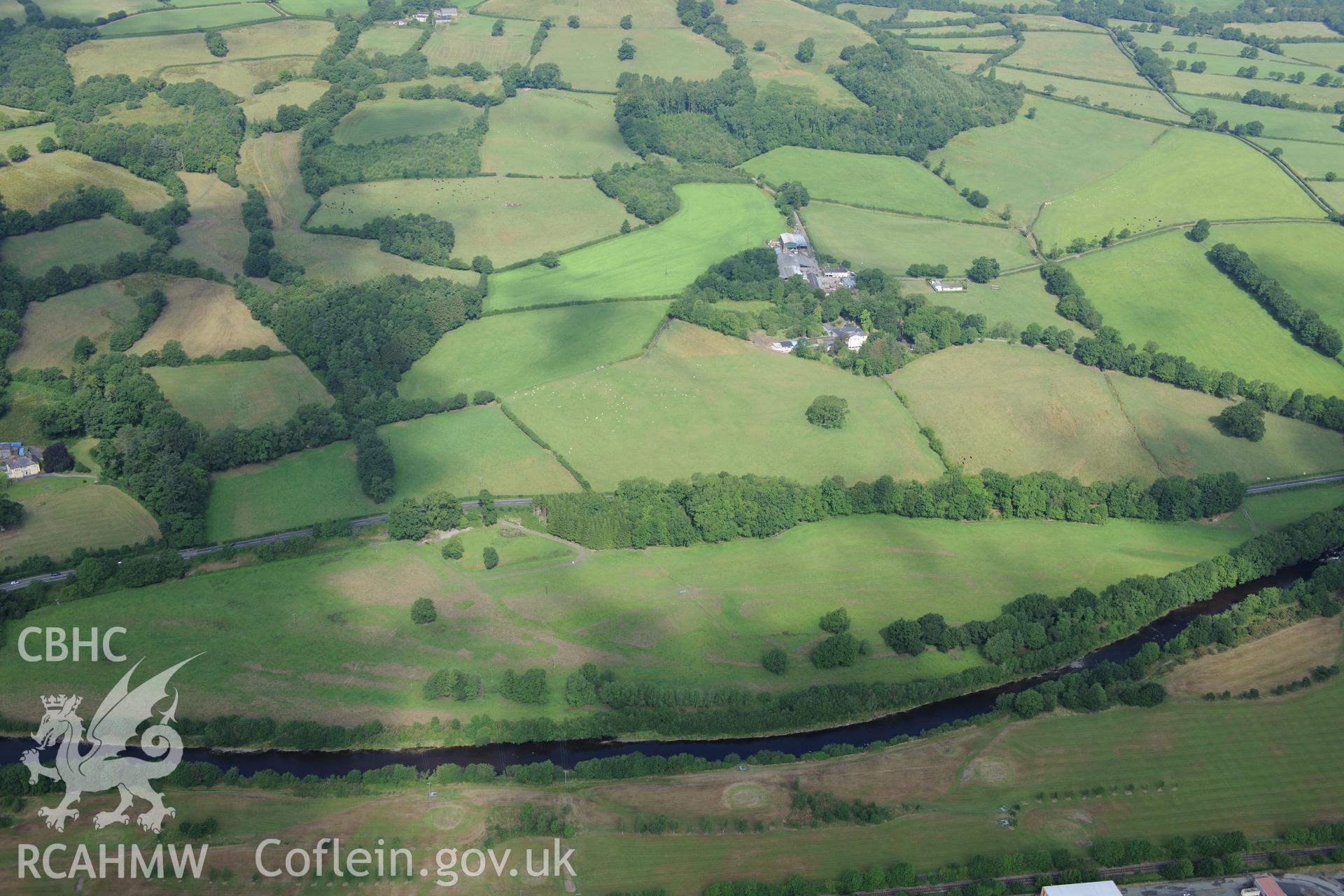 Blaenos Mansion and gardens, with Roman fortlet in diamond-shaped field immediately to the south west of the mansion and farm buildings. Oblique aerial photograph taken during the Royal Commission?s programme of archaeological aerial reconnaissance by Toby Driver on 1st August 2013.