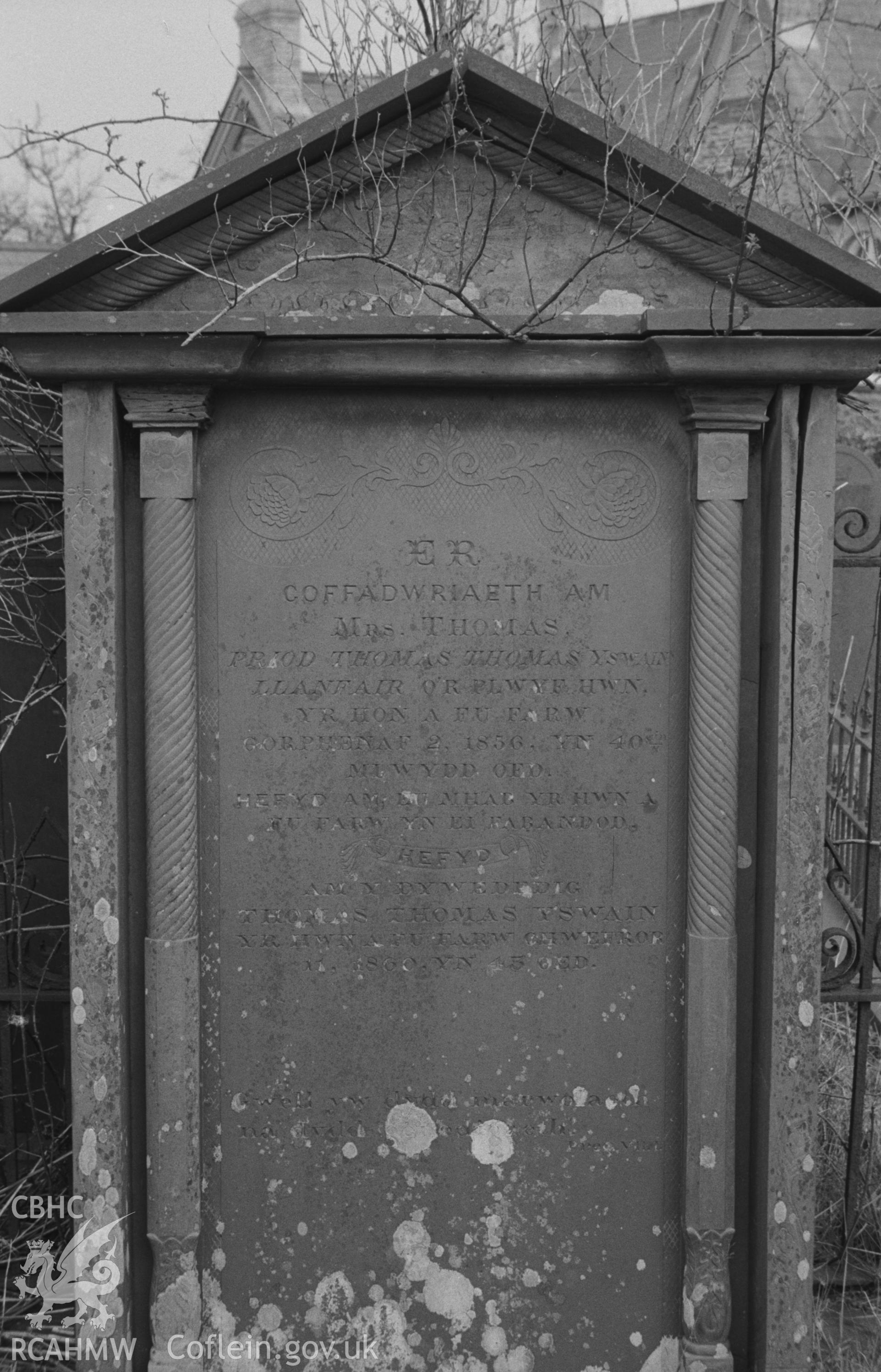 Digital copy of black & white negative showing gravestone in memory of members of the Thomas family of Llanfair at Capel Pant-y-Defaid, Prengwyn, Llandysul. Inside very fine wrought iron grave enclosures. Photographed by Arthur O. Chater on 11 April 1967.