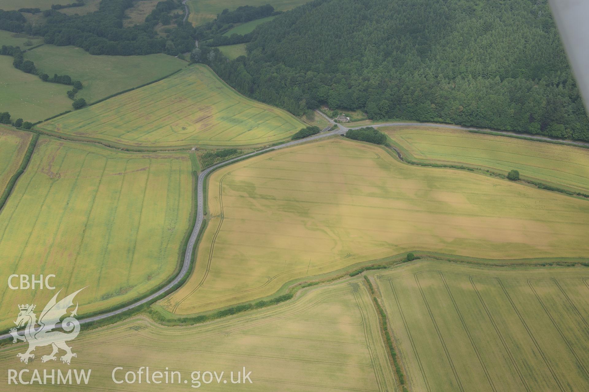 Ditchyeld bridge defended enclosure, and the section of Offa's Dyke from Ditchyeld bridge to country boundary, on the Welsh-English border south west of Presteigne. Oblique aerial photograph taken during the Royal Commission?s programme of archaeological