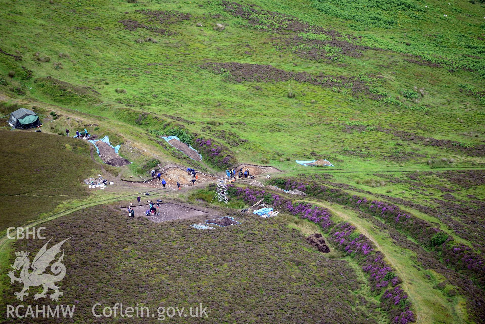 Penycloddiau Hilfort and Hut Platform V, Llangwyfan. Excavation by Liverpool University. Oblique aerial photograph taken during the Royal Commission's programme of archaeological aerial reconnaissance by Toby Driver on 30th July 2015.