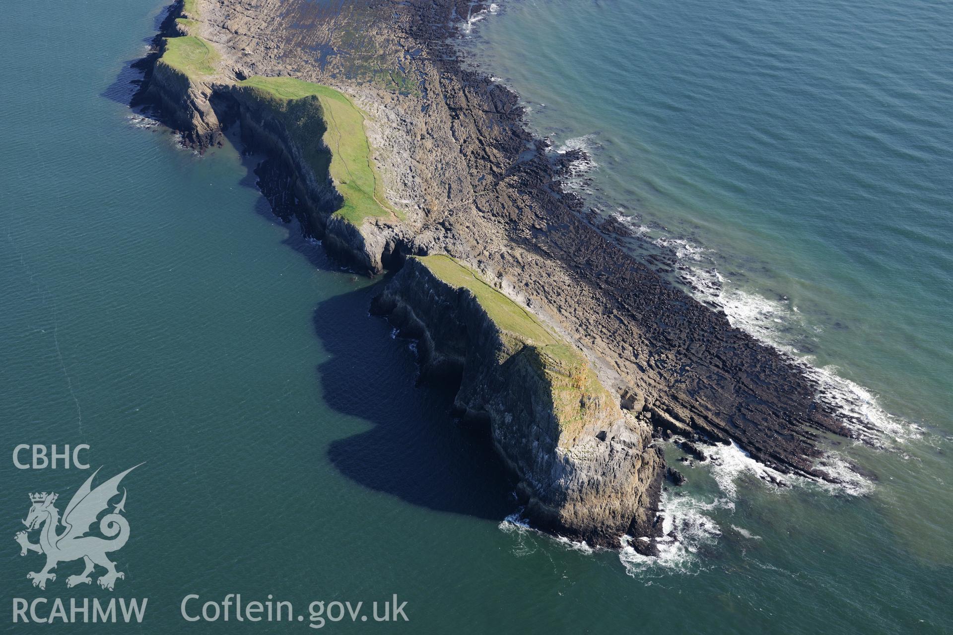 Cave on the western tip of Worms Head, which is on the western coast of the Gower Peninsula. Oblique aerial photograph taken during the Royal Commission's programme of archaeological aerial reconnaissance by Toby Driver on 30th September 2015.