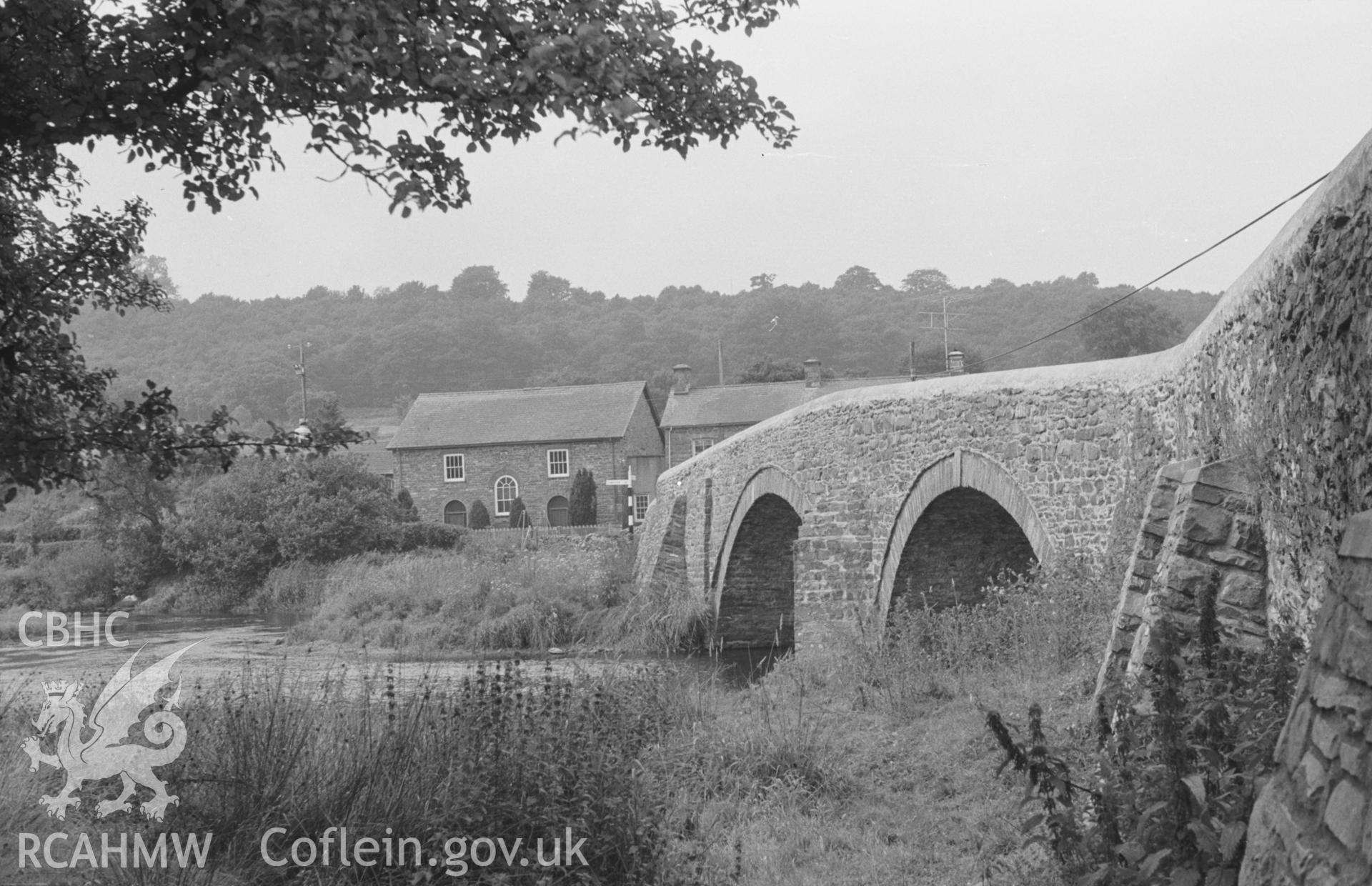 Digital copy of black & white negative showing view of Capel Mair Welsh Independent Chapel and Pont Llanfair over the river Teifi at Llanfair Clydogau. Photographed by Arthur O. Chater in August 1965 from Grid Ref SN 6227 5137, looking west north west.