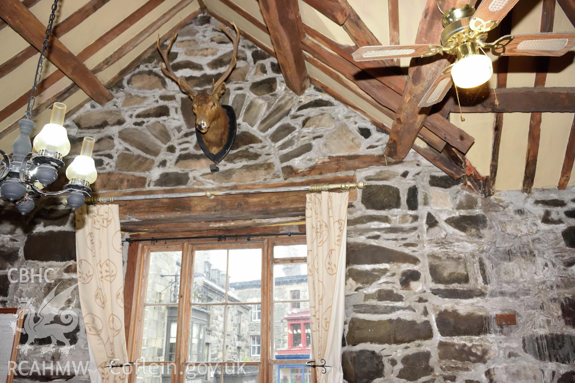 Colour photograph showing view looking east at eastern gable of first floor restaurant at Y Sospan, Llys Owain, Dolgellau. Photographed by I. P. Brookes of Engineering Archaeological Services, June 2019.